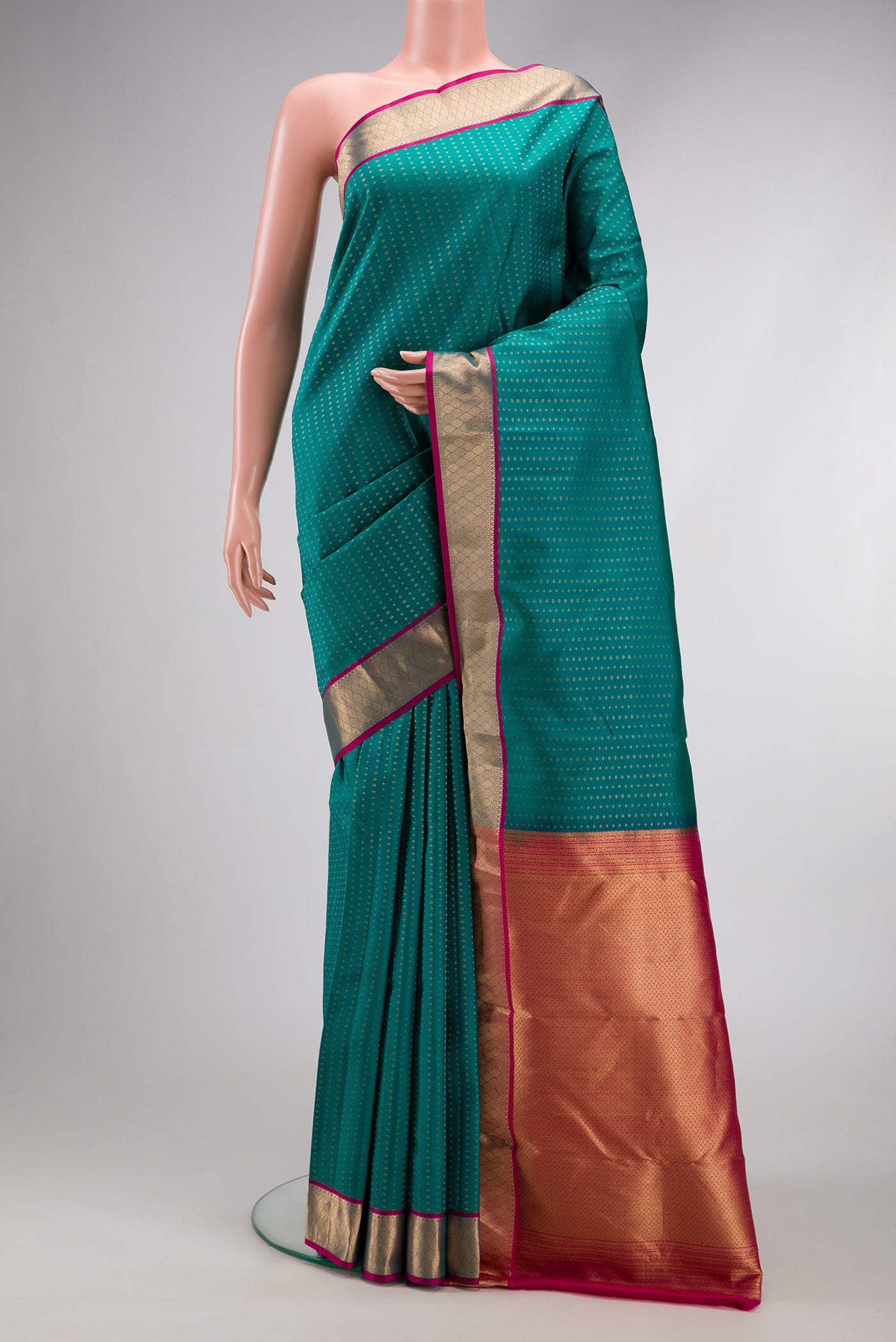 Green Dual Tone Kanchipuram Silk Saree with Stripes on the body and Zari Border.  displayed on a mannequin