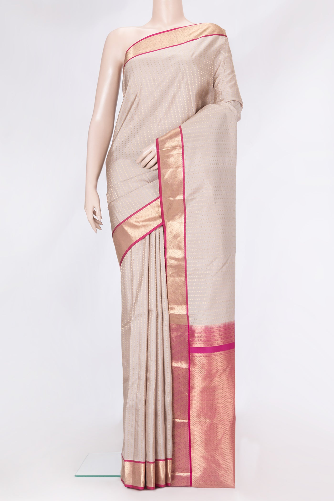 Rose Gold Dual Tone Kanchipuram Silk Saree with Zari Butta on the body and Zari Border.  displayed on a mannequin
