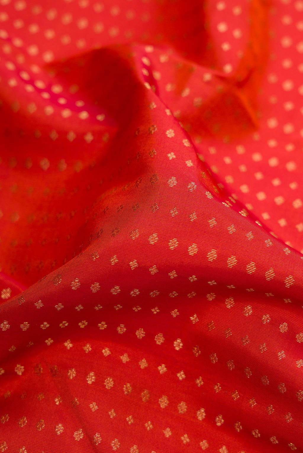 Close up of Brick Orange Dual Tone Kanchipuram Silk Saree with Stripes on the body and Zari Border.  displaying folds