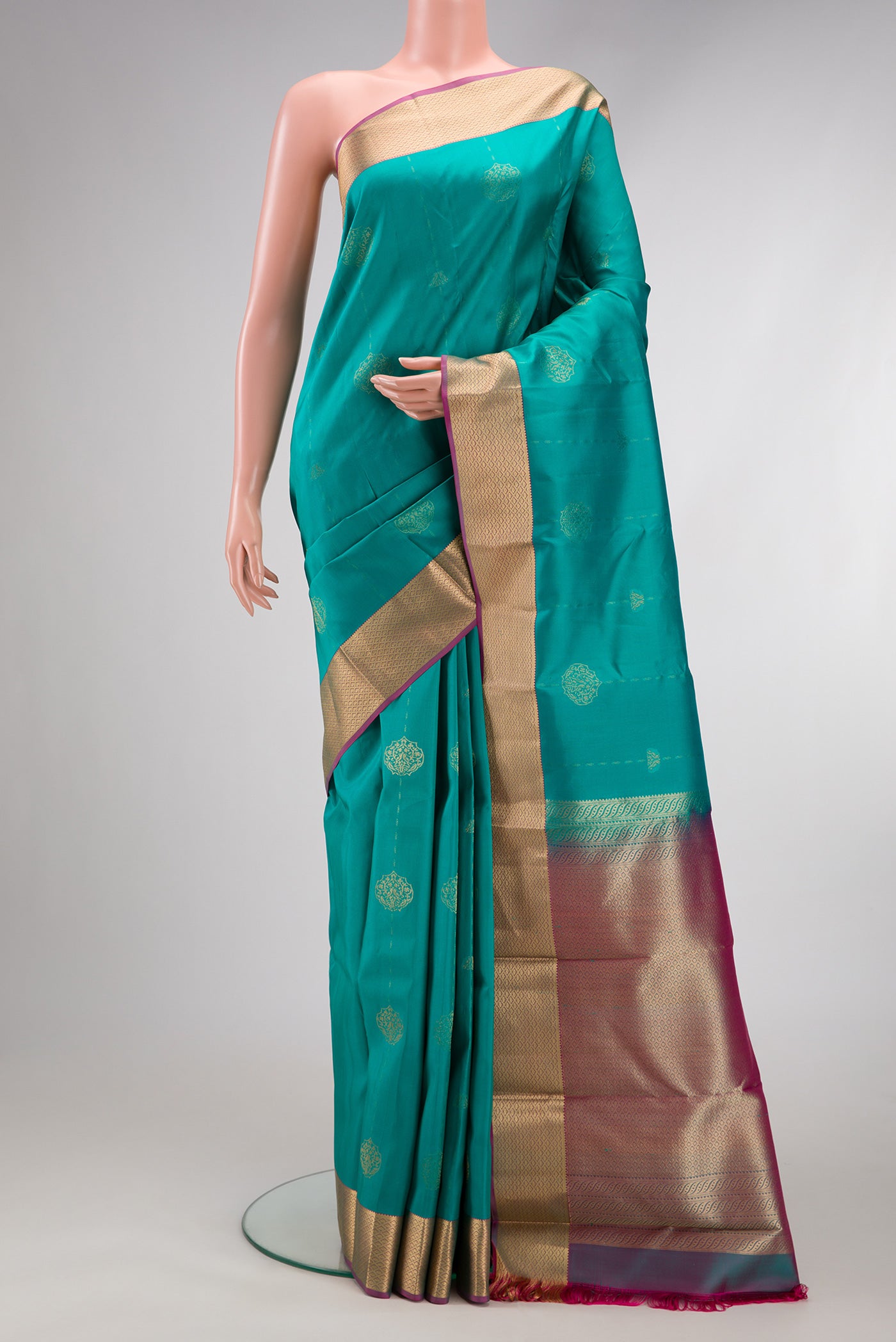 Sky Blue Kanchipuram Silk Saree with Zari Butta on the body and Zari Border.  displayed on a mannequin