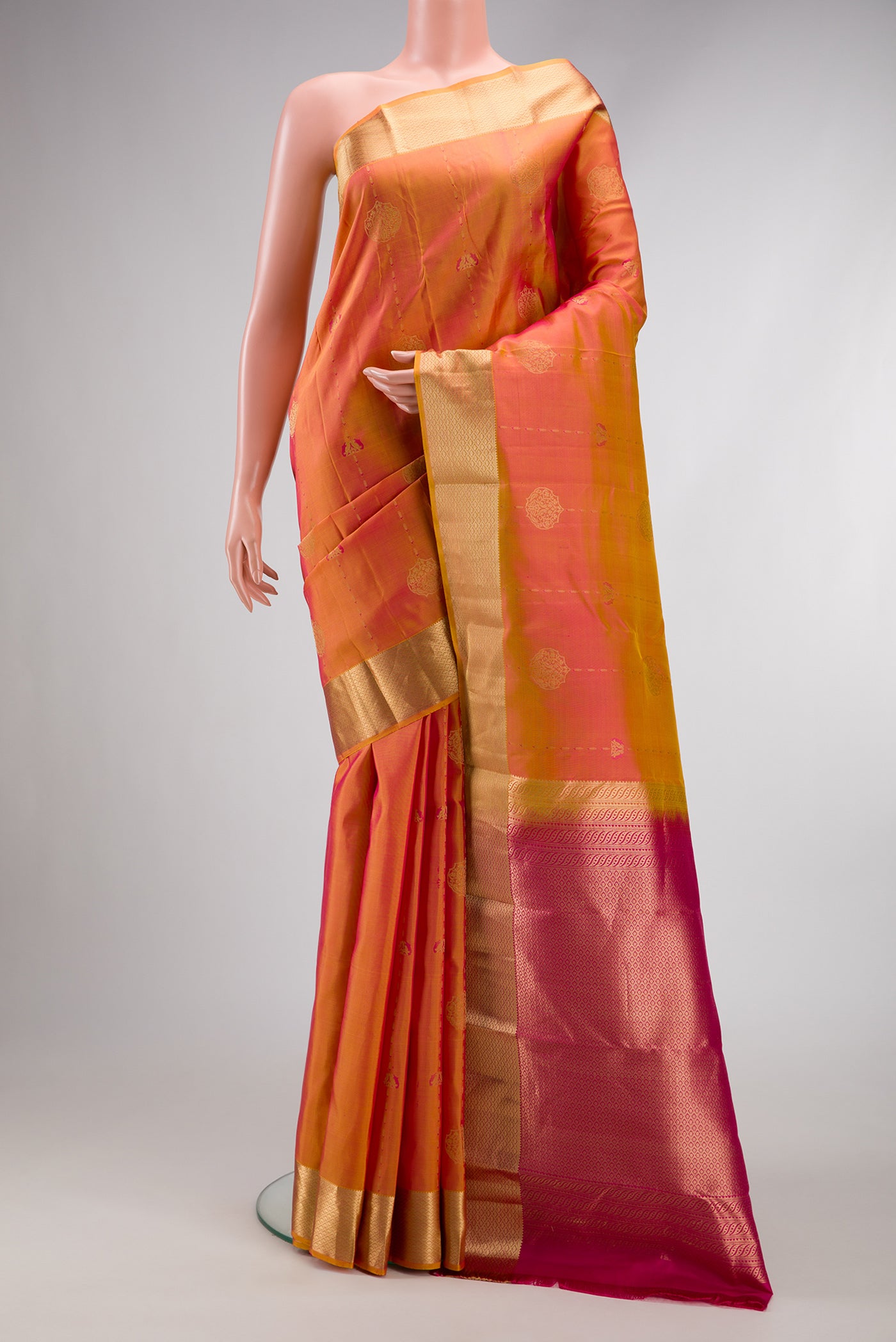 Coral Dual Tone Kanchipuram Silk Saree with Zari Butta on the body and Zari Border.  displayed on a mannequin