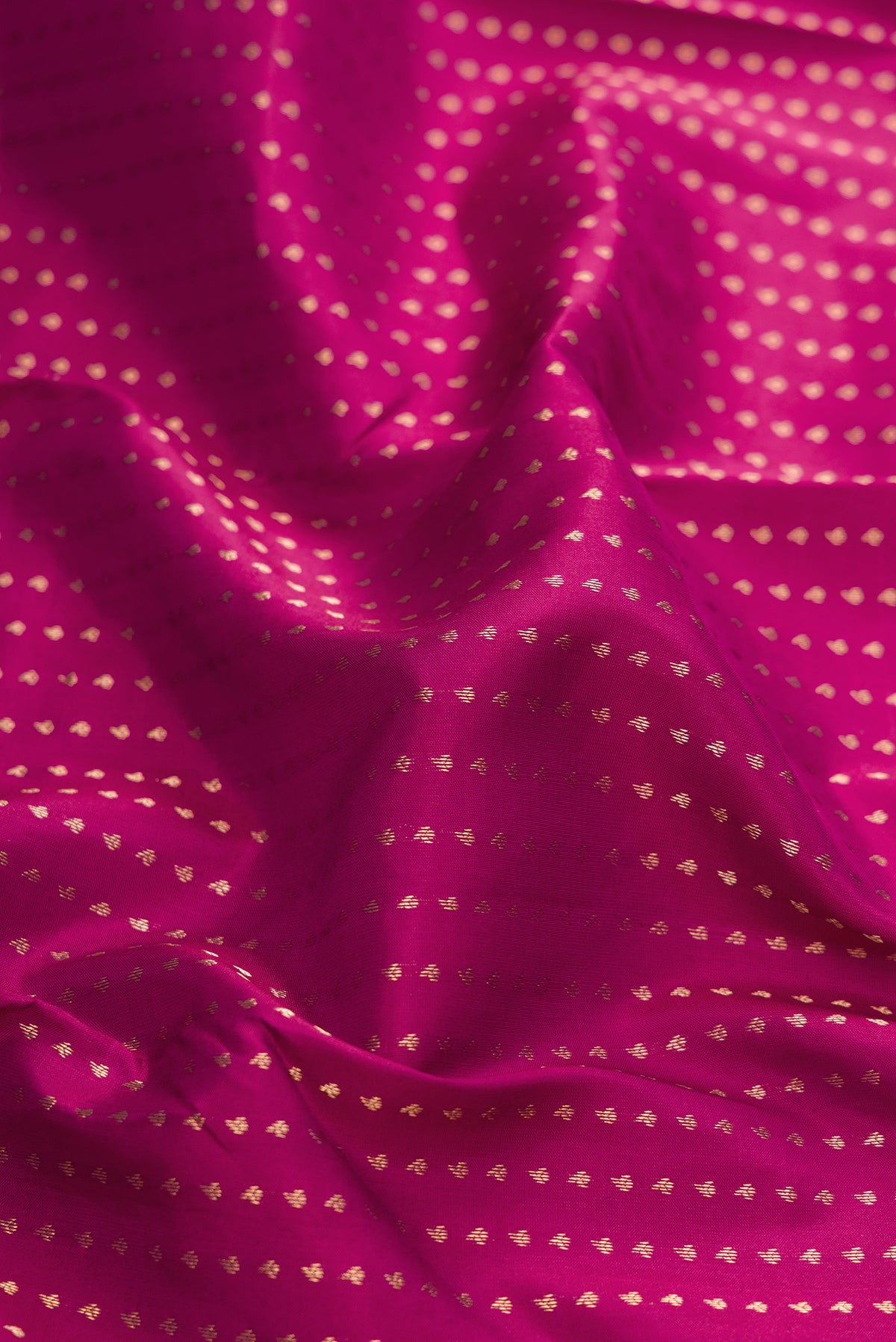 Close up of Maroon Dual Tone Kanchipuram Silk Saree with Stripes on the body and Fancy Border.  displaying folds