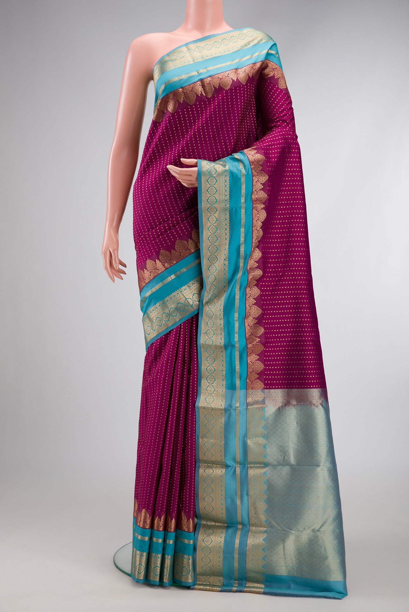 Maroon Dual Tone Kanchipuram Silk Saree with Stripes on the body and Fancy Border.  displayed on a mannequin