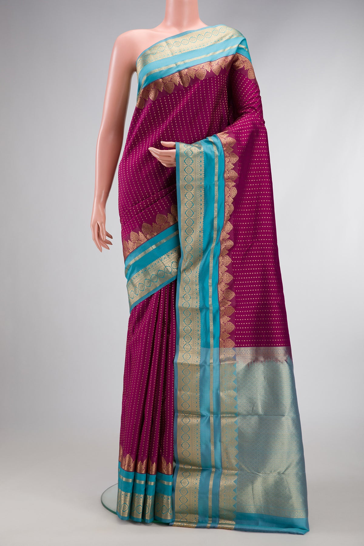 Maroon Dual Tone Kanchipuram Silk Saree with Stripes on the body and Fancy Border.  displayed on a mannequin