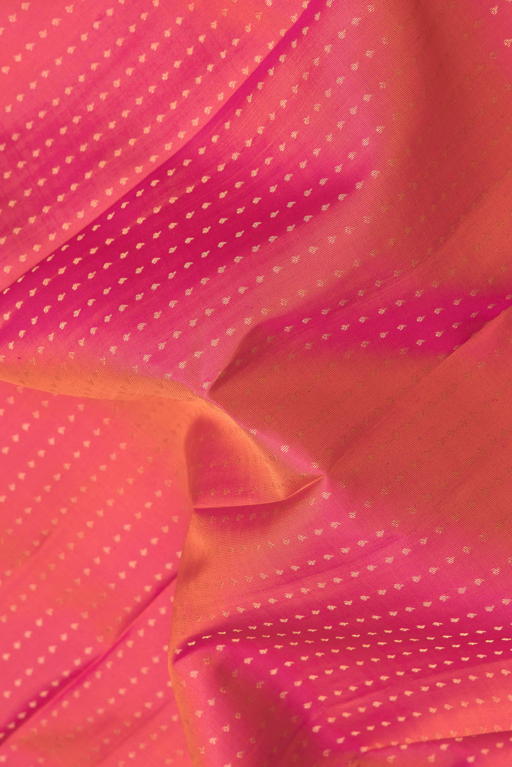Close up of Pink Dual Tone Kanchipuram Silk Saree with Zari Butta on the body and Zari Border.  displaying folds