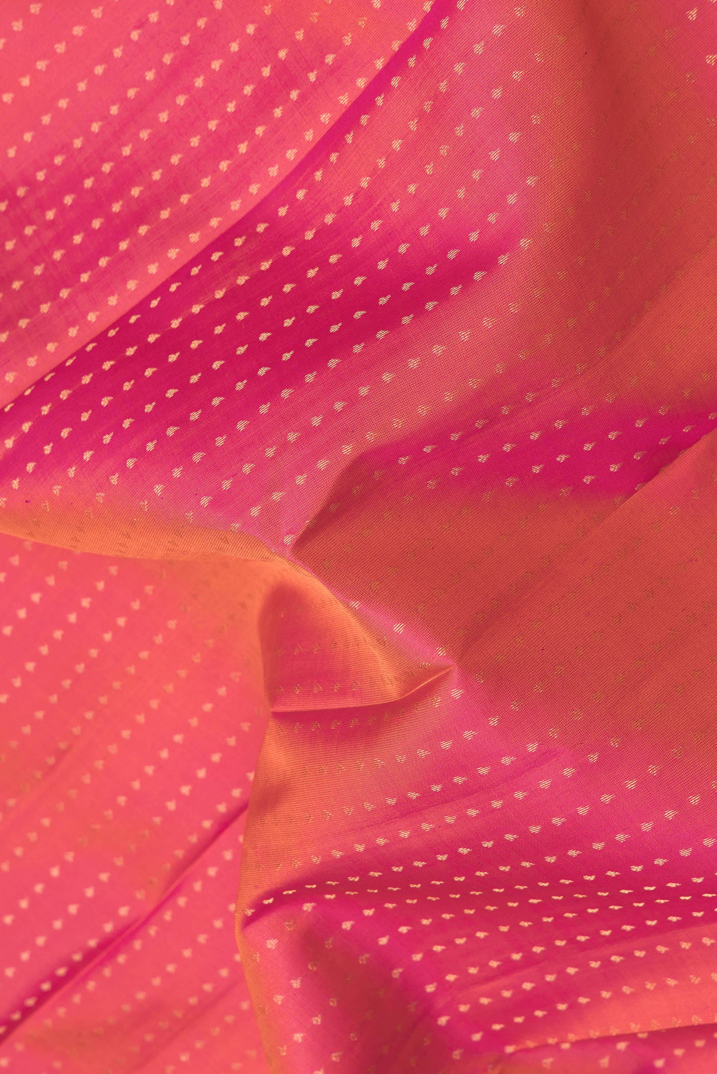 Close up of Pink Dual Tone Kanchipuram Silk Saree with Zari Butta on the body and Zari Border.  displaying folds