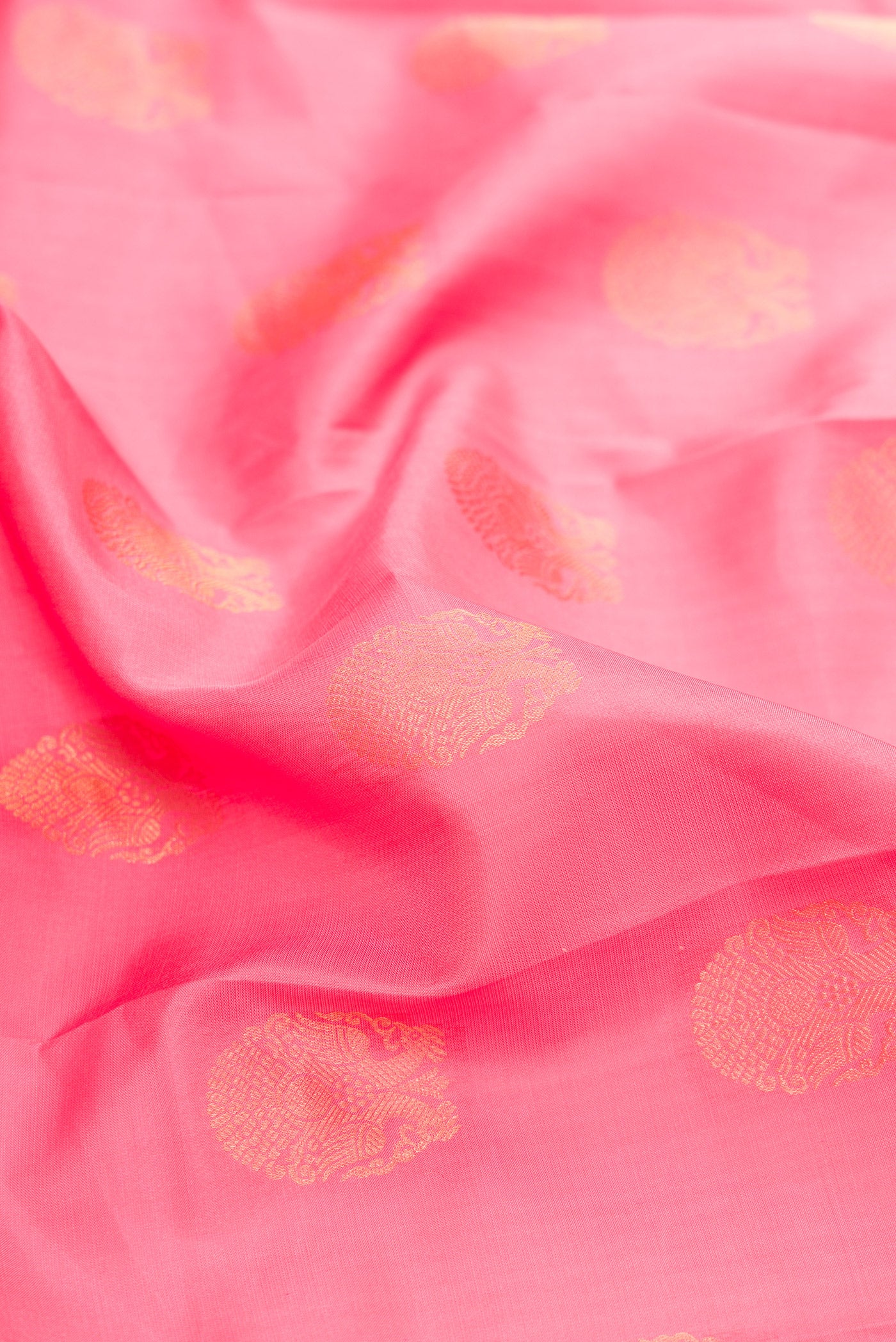Close up of Pink Dual Tone Kanjivaram Silk Saree with Zari Butta on the body and Zari Border.  displaying folds