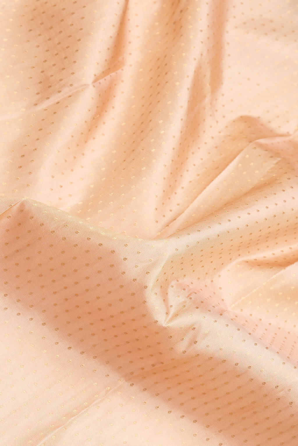 Close up of Caramel Dual Tone Kanchipuram Silk Saree with Zari Butta on the body and Zari Border.  displaying folds