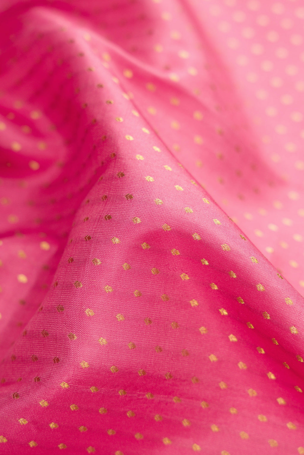 Close up of Pink Dual Tone Kanchipuram Silk Saree with Zari Butta on the body and Zari Border.  displaying folds
