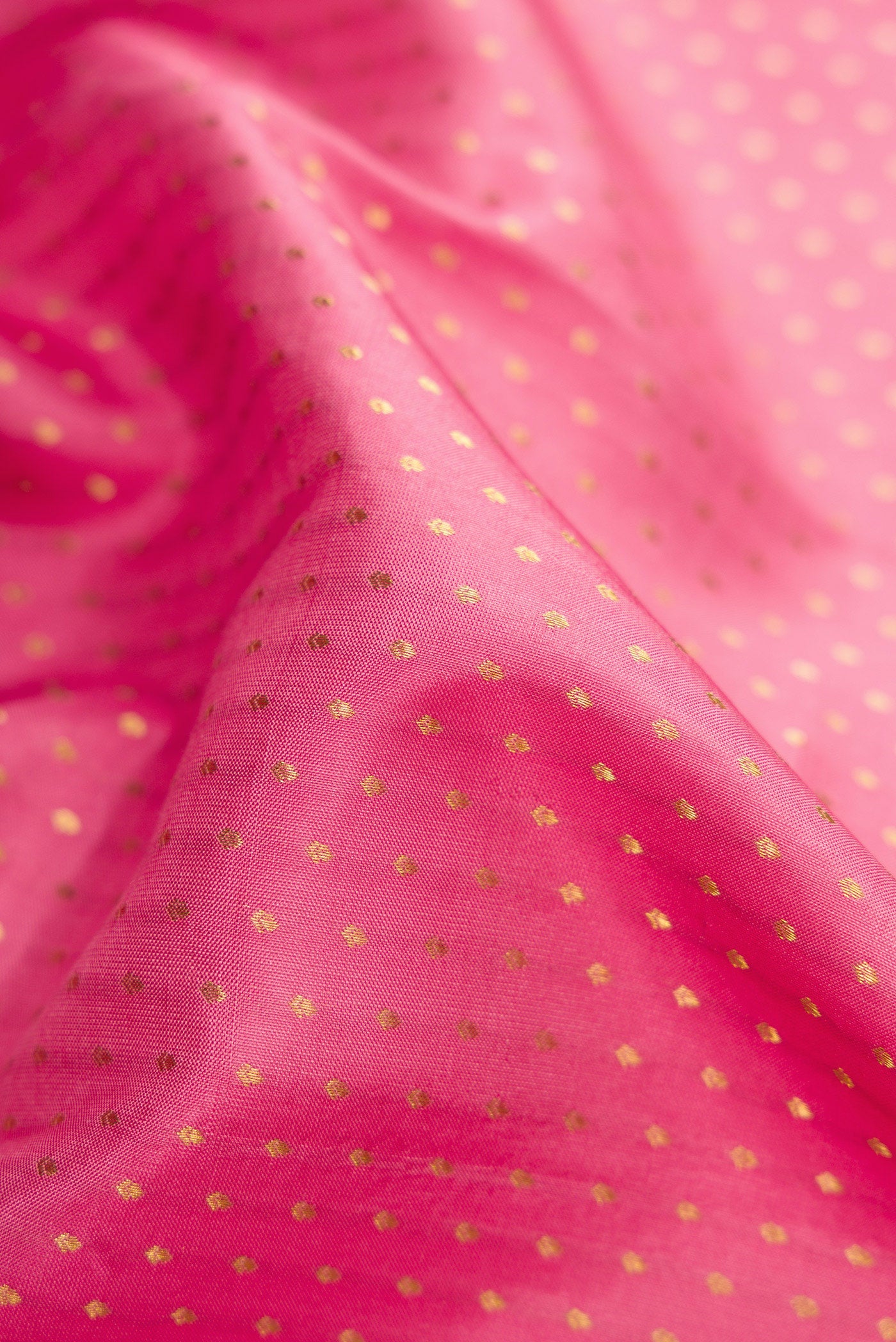 Close up of Pink Dual Tone Kanchipuram Silk Saree with Zari Butta on the body and Zari Border.  displaying folds