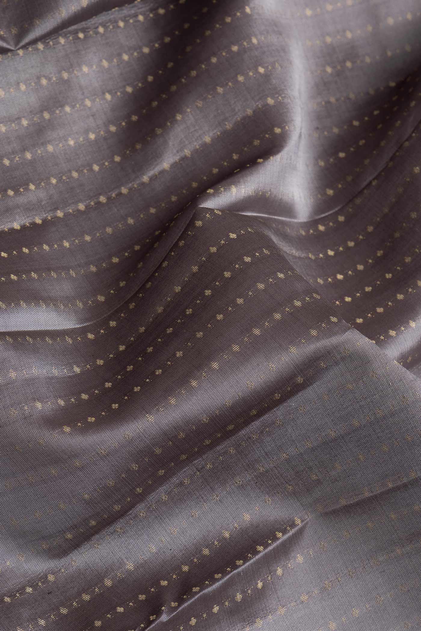 Close up of Grey Dual Tone Kanchipuram Silk Saree with Zari Butta on the body and Zari Border.  displaying folds