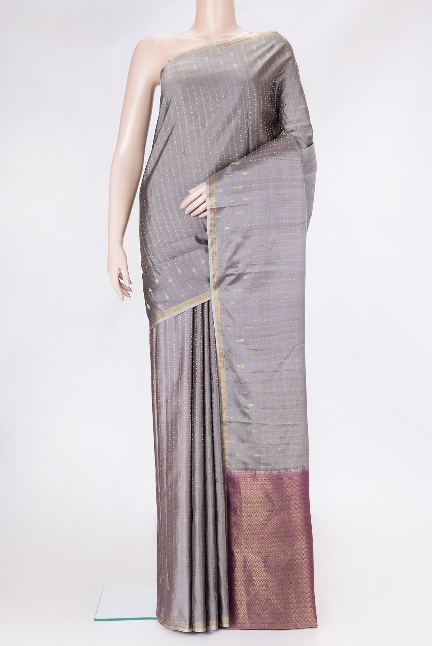 Grey Dual Tone Kanchipuram Silk Saree with Zari Butta on the body and Zari Border.  displayed on a mannequin