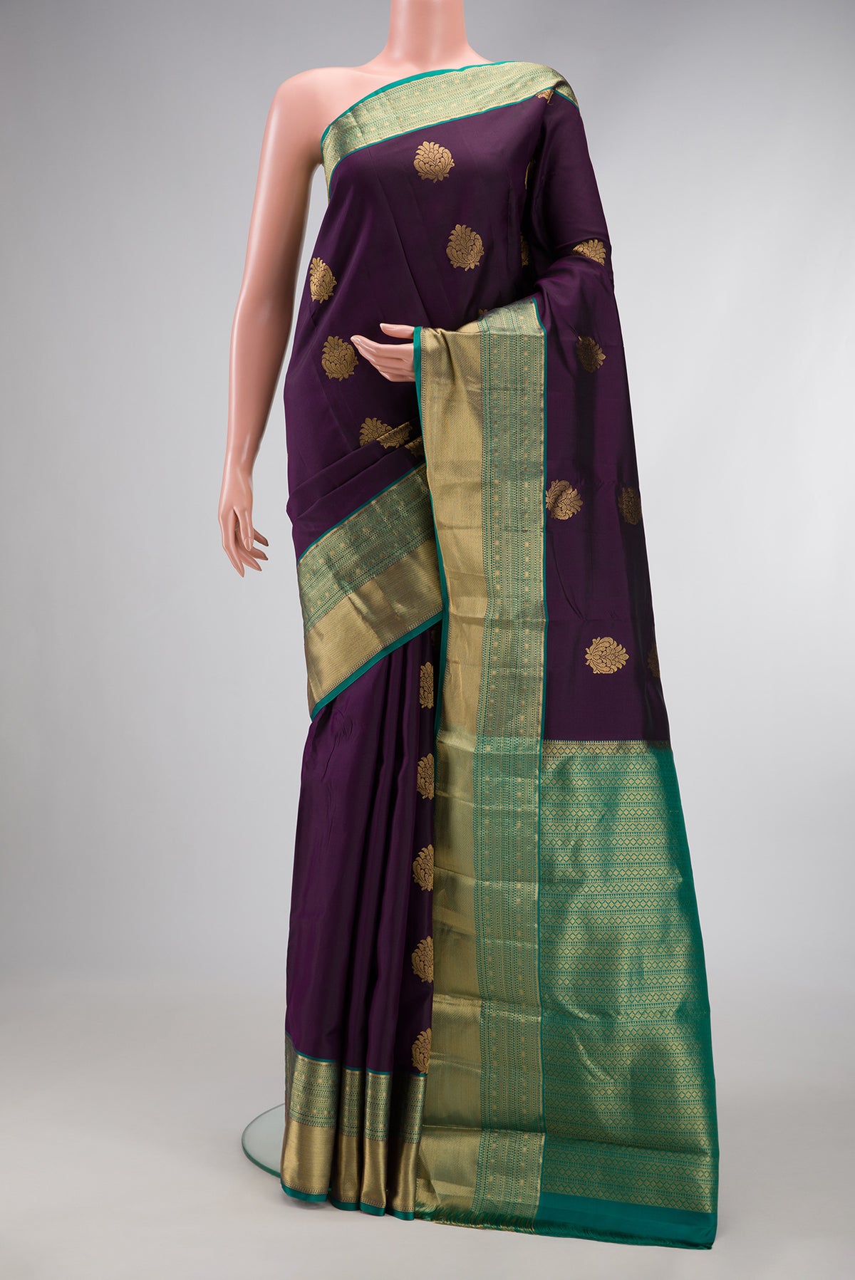 Burgundy Dual Tone Kanchipuram Silk Saree with Zari Butta on the body and Zari Border.  displayed on a mannequin