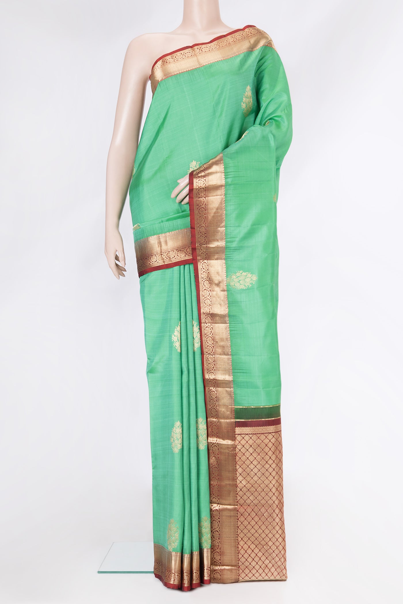 Pista Green Dual Tone Kanjivaram Silk Saree with Zari Butta on the body and Zari Border.  displayed on a mannequin