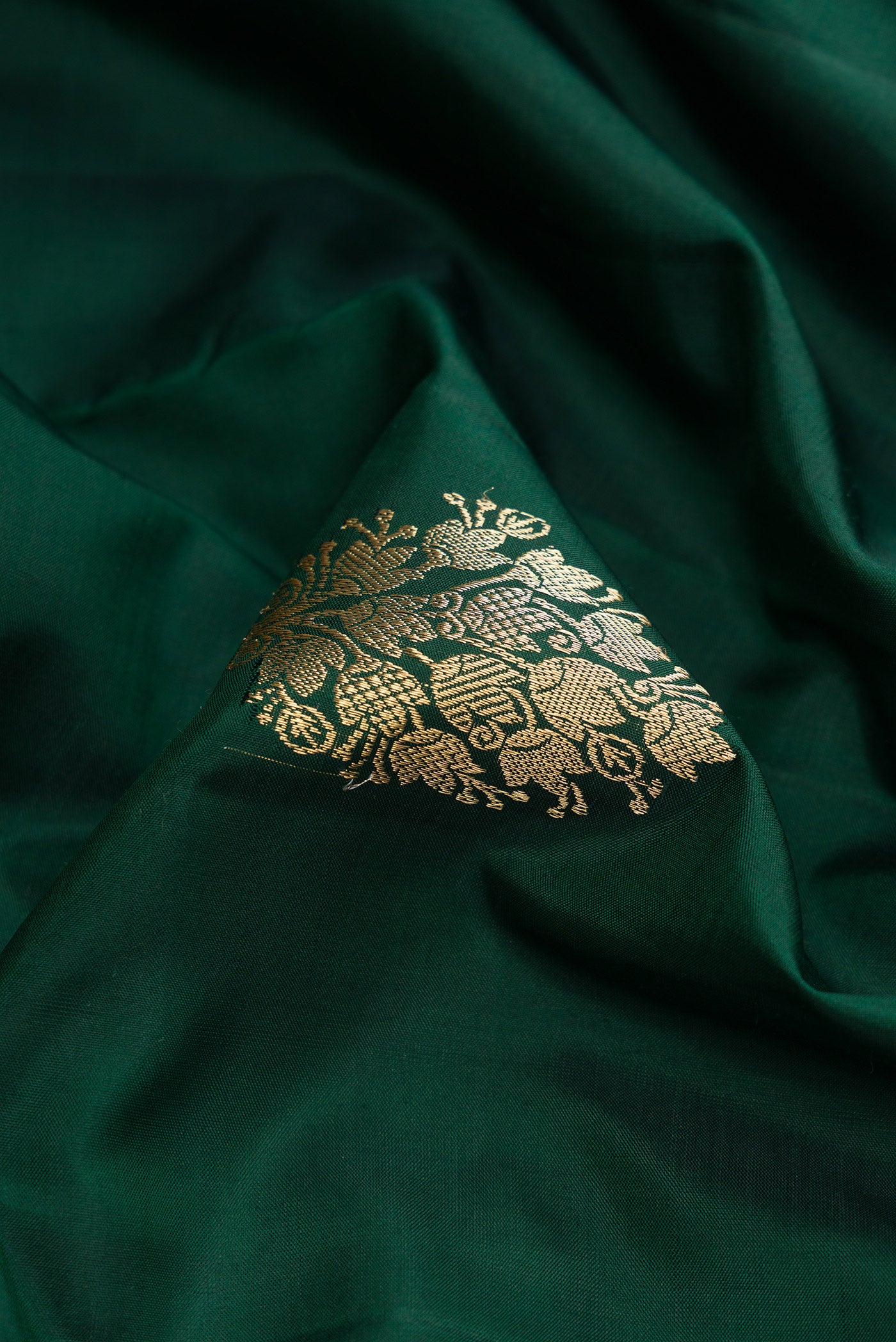 Close up of Bottle Green Dual Tone Kanjivaram Silk Saree with Zari Butta on the body and Zari Border.  displaying folds