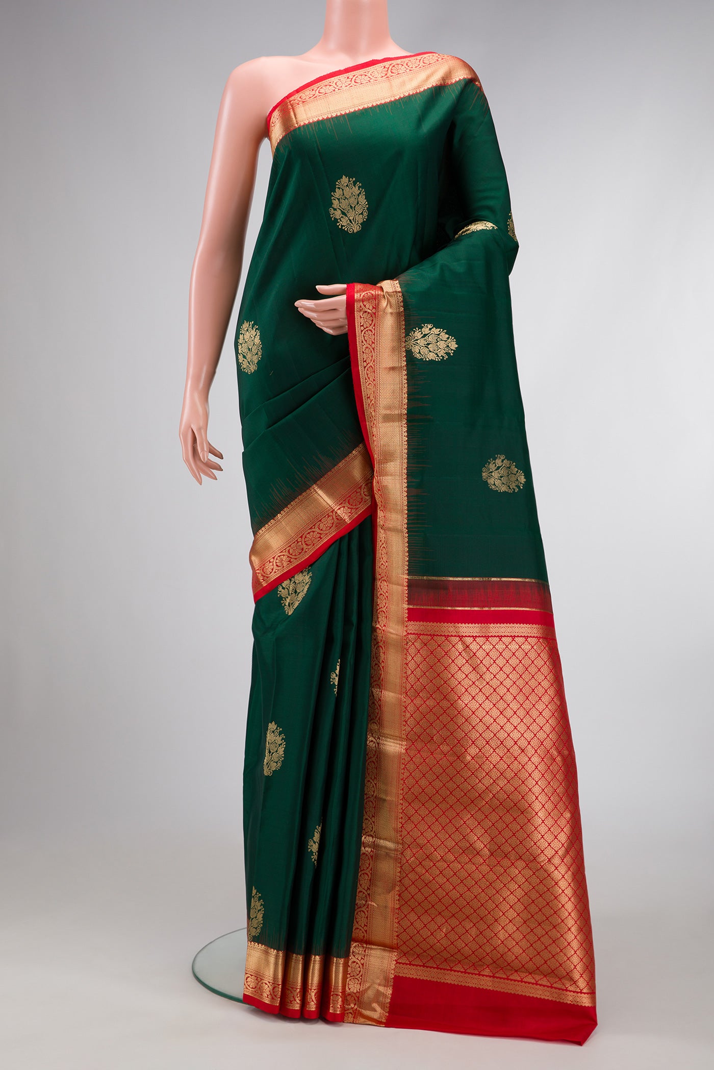 Bottle Green Dual Tone Kanjivaram Silk Saree with Zari Butta on the body and Zari Border.  displayed on a mannequin