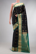 Black Dual Tone Kanjivaram Silk Saree with Zari Butta on the body and Zari Border.  displayed on a mannequin