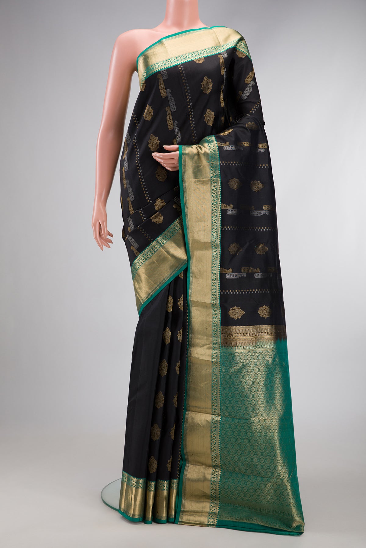 Black Dual Tone Kanjivaram Silk Saree with Zari Butta on the body and Zari Border.  displayed on a mannequin