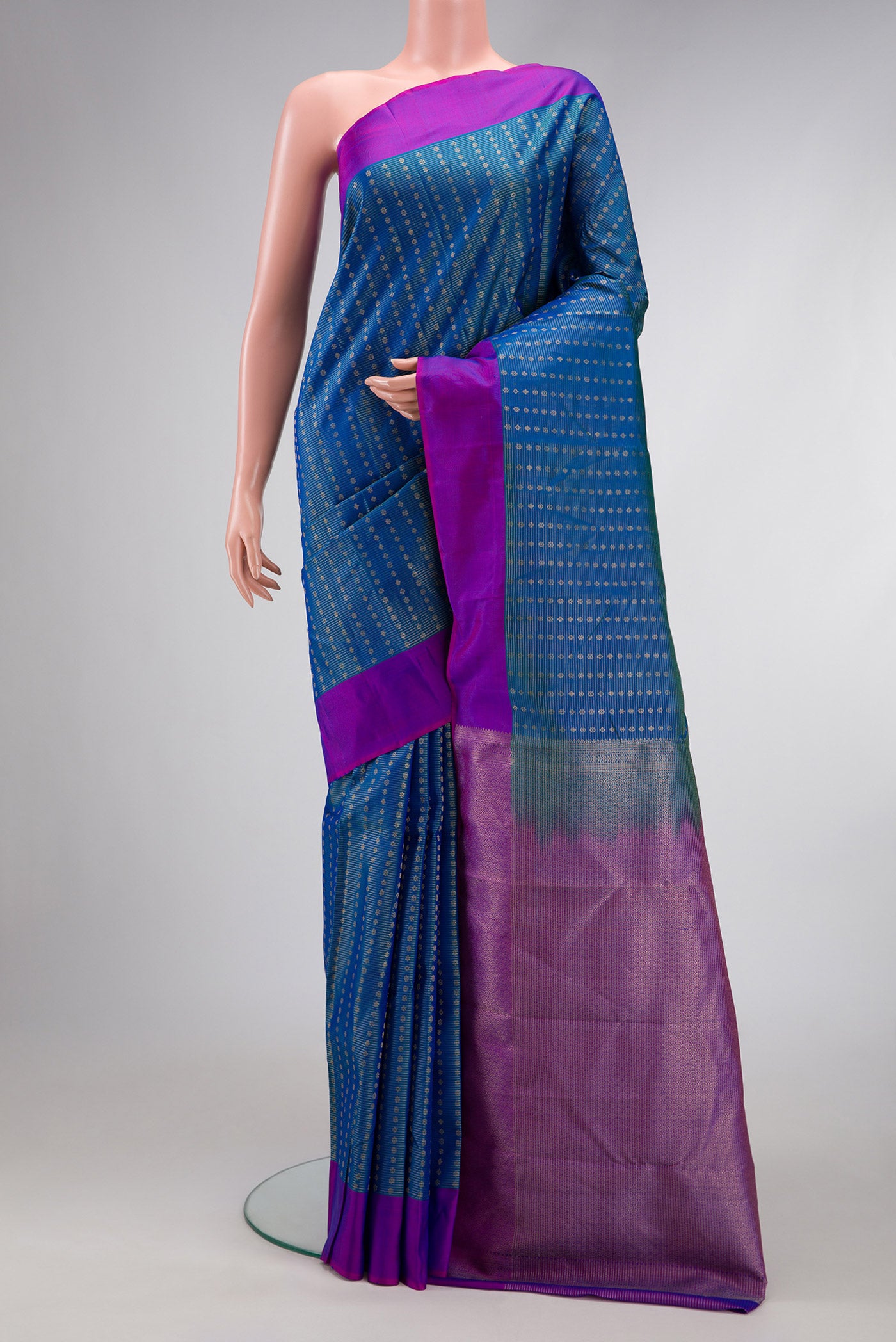 Peacock Blue Dual Tone Kanchipuram Silk Saree with Stripes on the body and Plain Border.  displayed on a mannequin