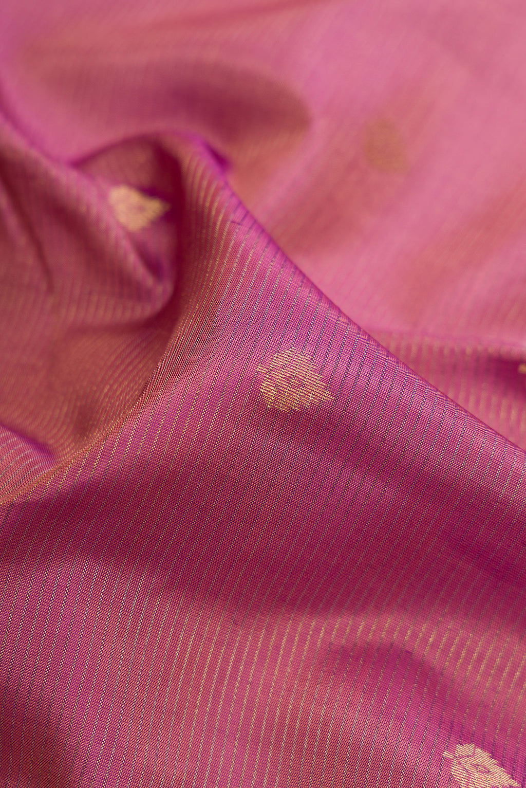Close up of Rose pink Dual Tone Kanchipuram Silk Saree with Zari Butta on the body and Zari Border.  displaying folds