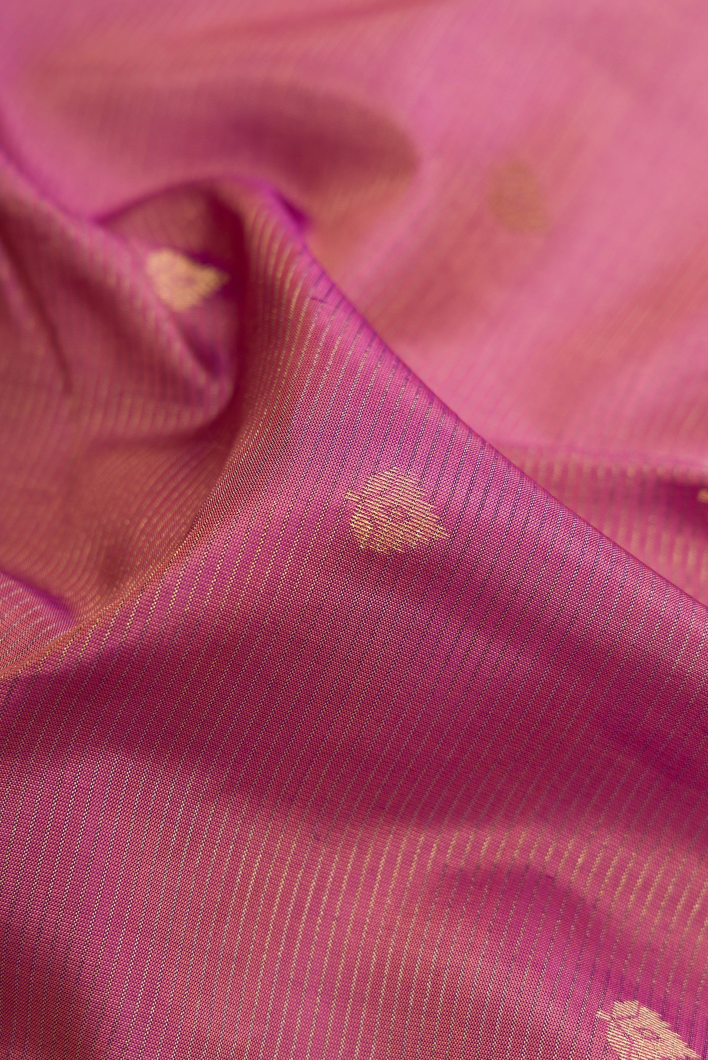 Close up of Rose pink Dual Tone Kanchipuram Silk Saree with Zari Butta on the body and Zari Border.  displaying folds