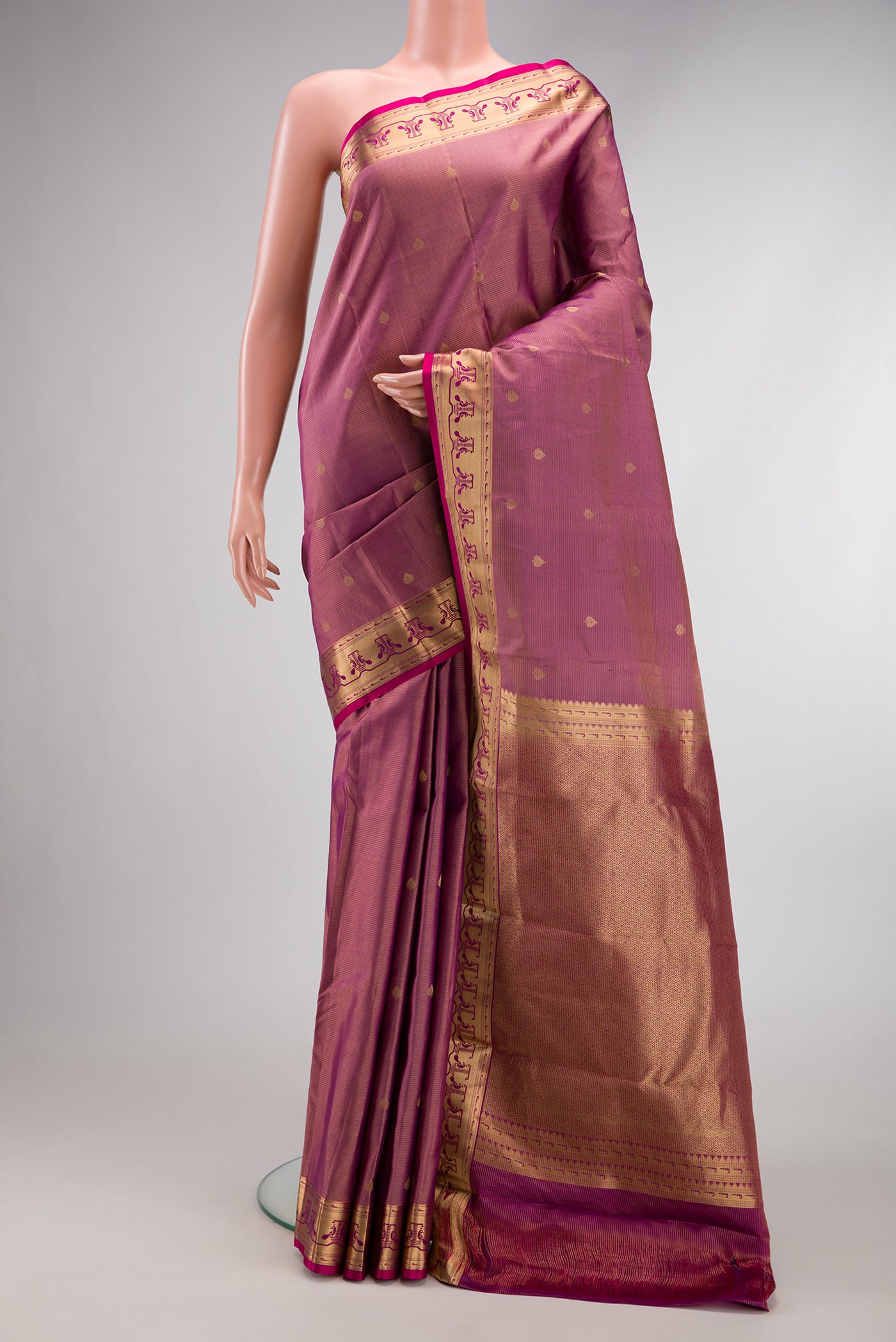 Rose pink Dual Tone Kanchipuram Silk Saree with Zari Butta on the body and Zari Border.  displayed on a mannequin