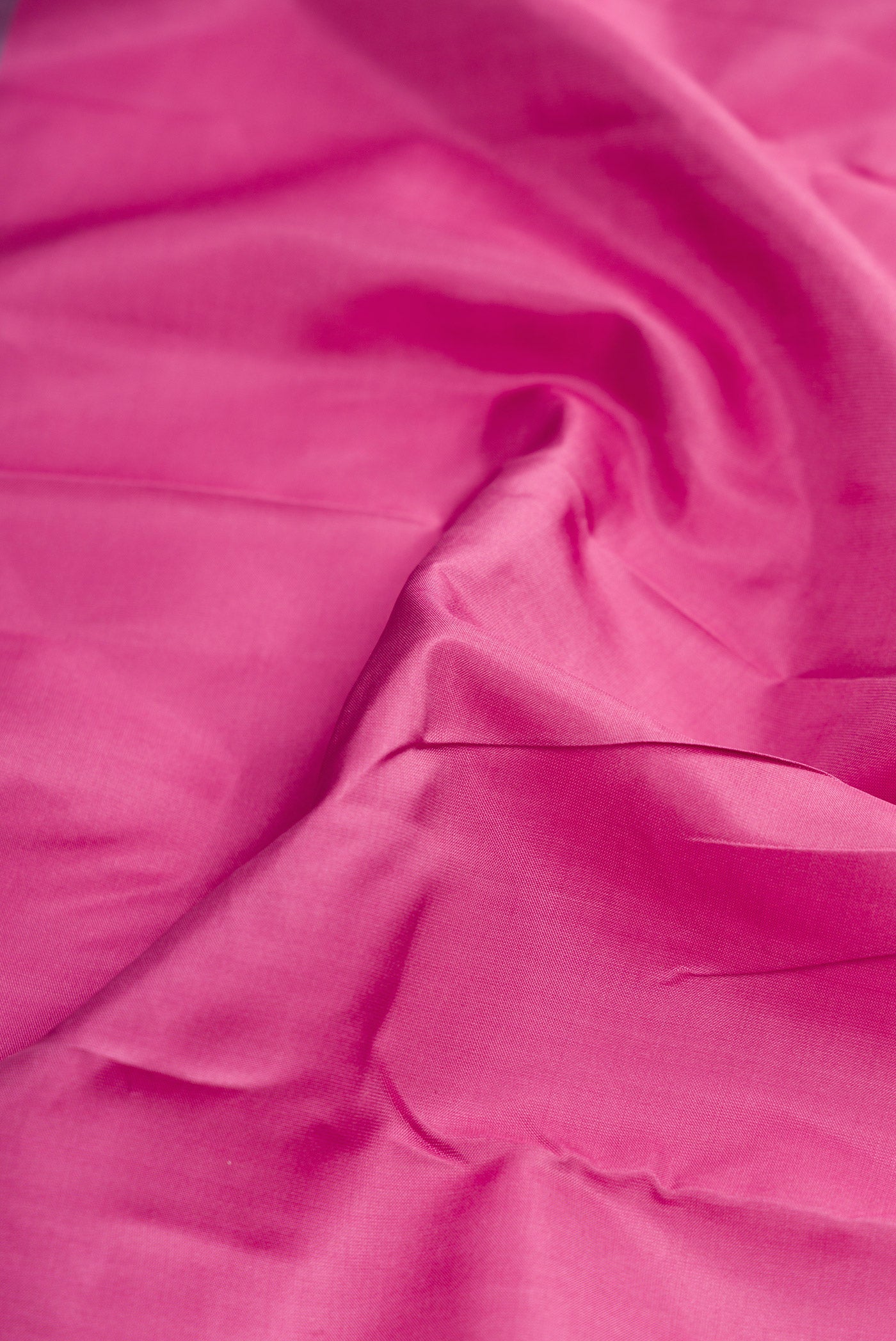 Close up of Pink Dual Tone Kanchipuram Silk Saree with Plain Body and Fancy Border.  displaying folds