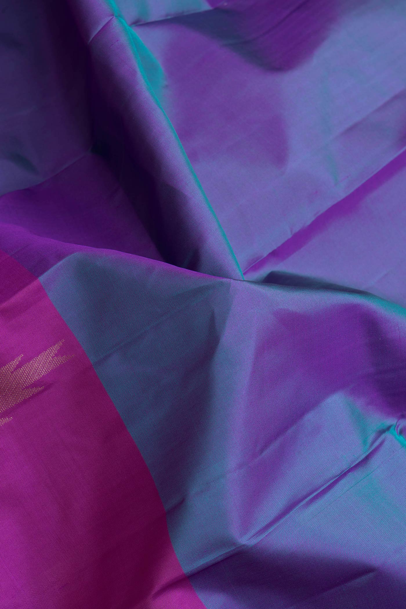 Close up of Peacock Blue Dual Tone Kanchipuram Silk Saree with Plain Body and Fancy Border.  displaying folds