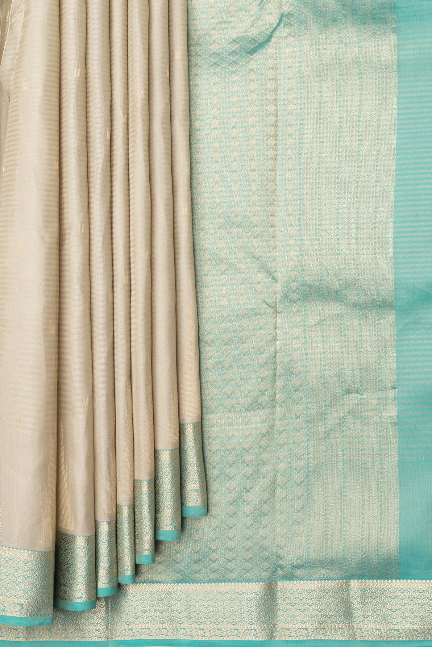 Pleats and pallu of Beige Kanchipuram Silk Saree with Stripes on the body and Zari Border. 
