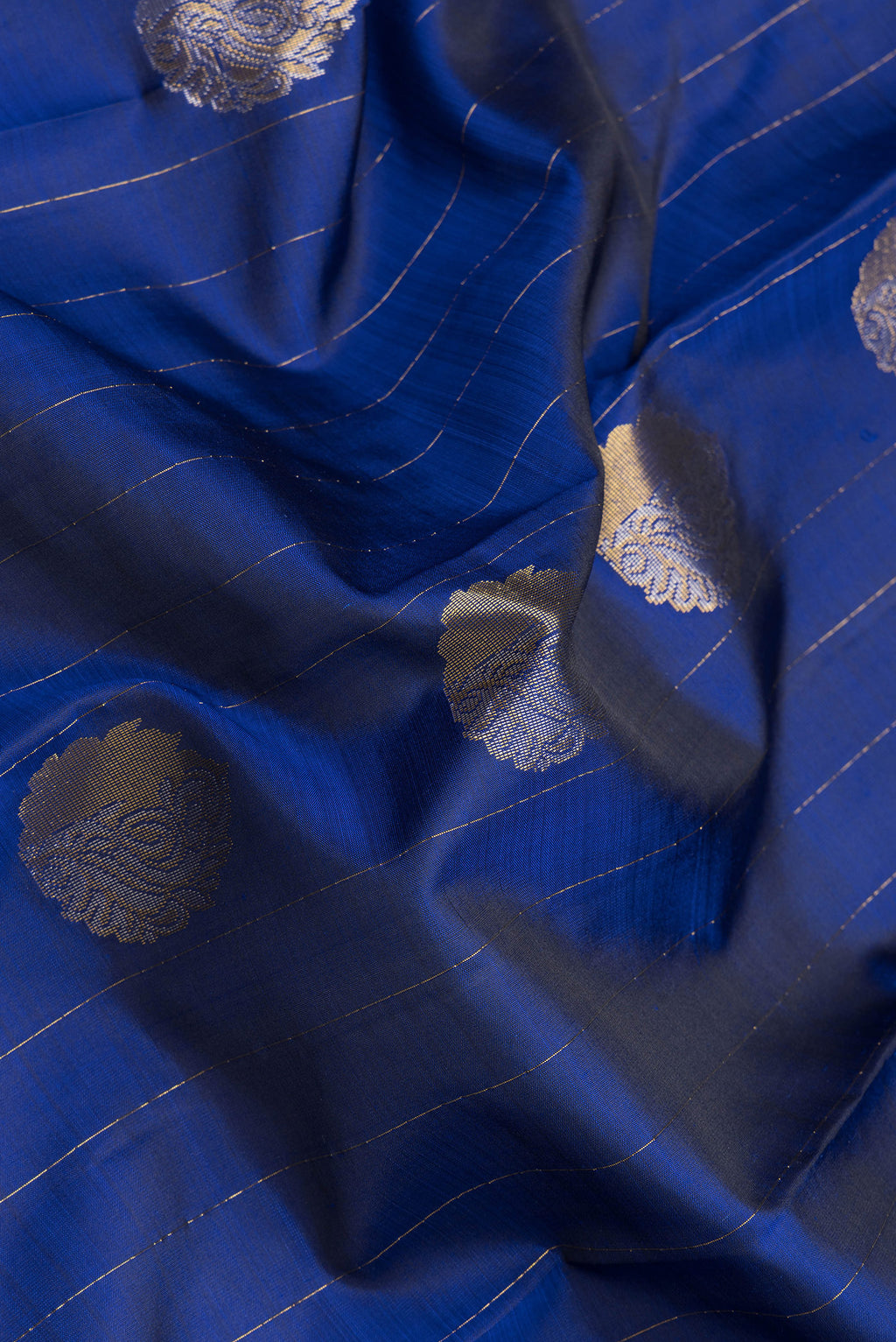 Close up of Navy Blue Dual Tone Kanchipuram Silk Saree with Stripes on the body and Fancy Border.  displaying folds