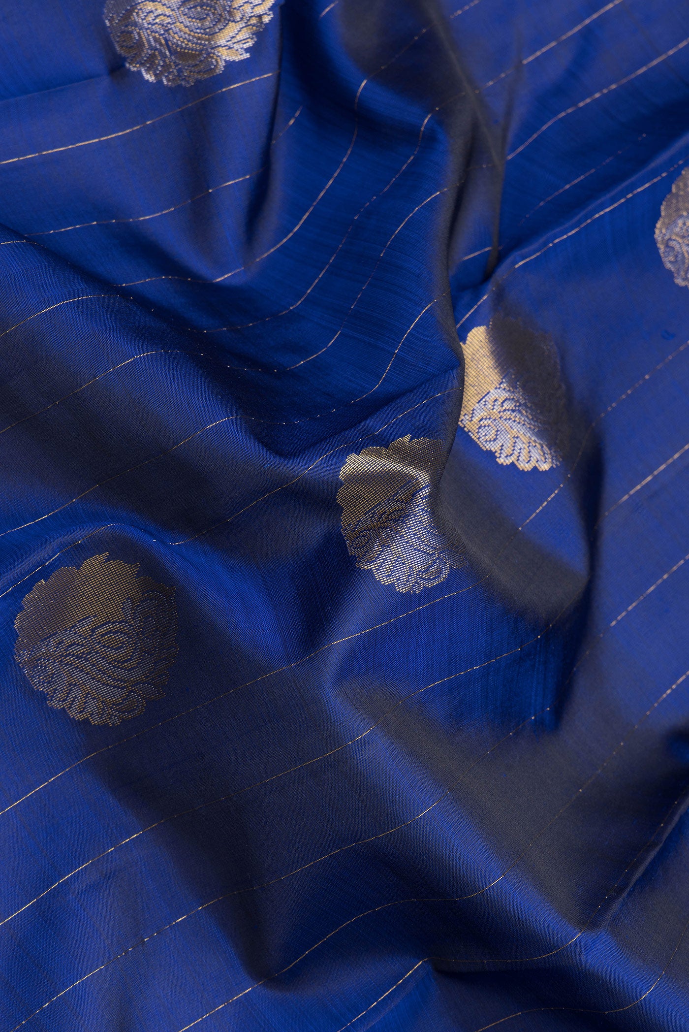 Close up of Navy Blue Dual Tone Kanchipuram Silk Saree with Stripes on the body and Fancy Border.  displaying folds