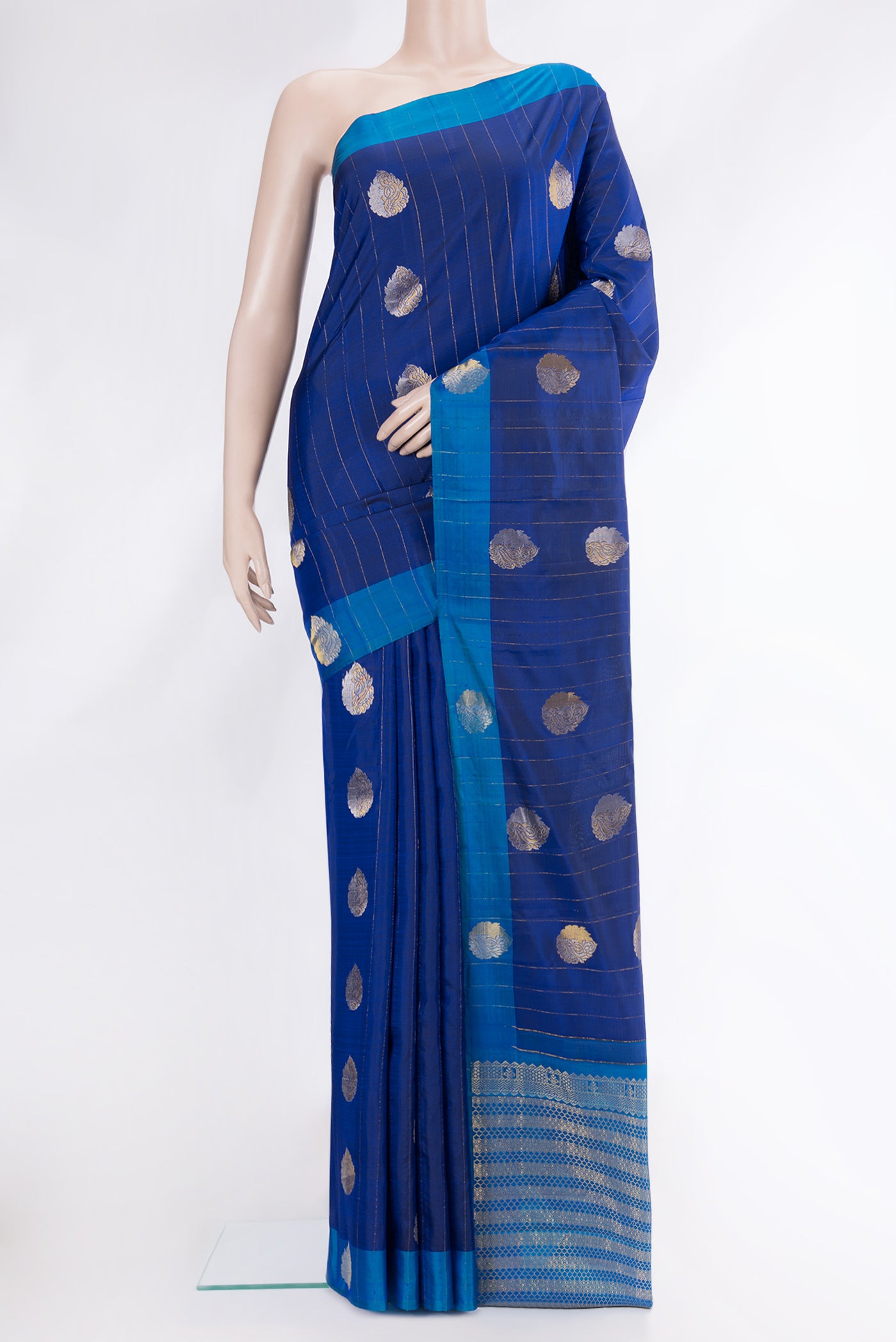 Navy Blue Dual Tone Kanchipuram Silk Saree with Stripes on the body and Fancy Border.  displayed on a mannequin