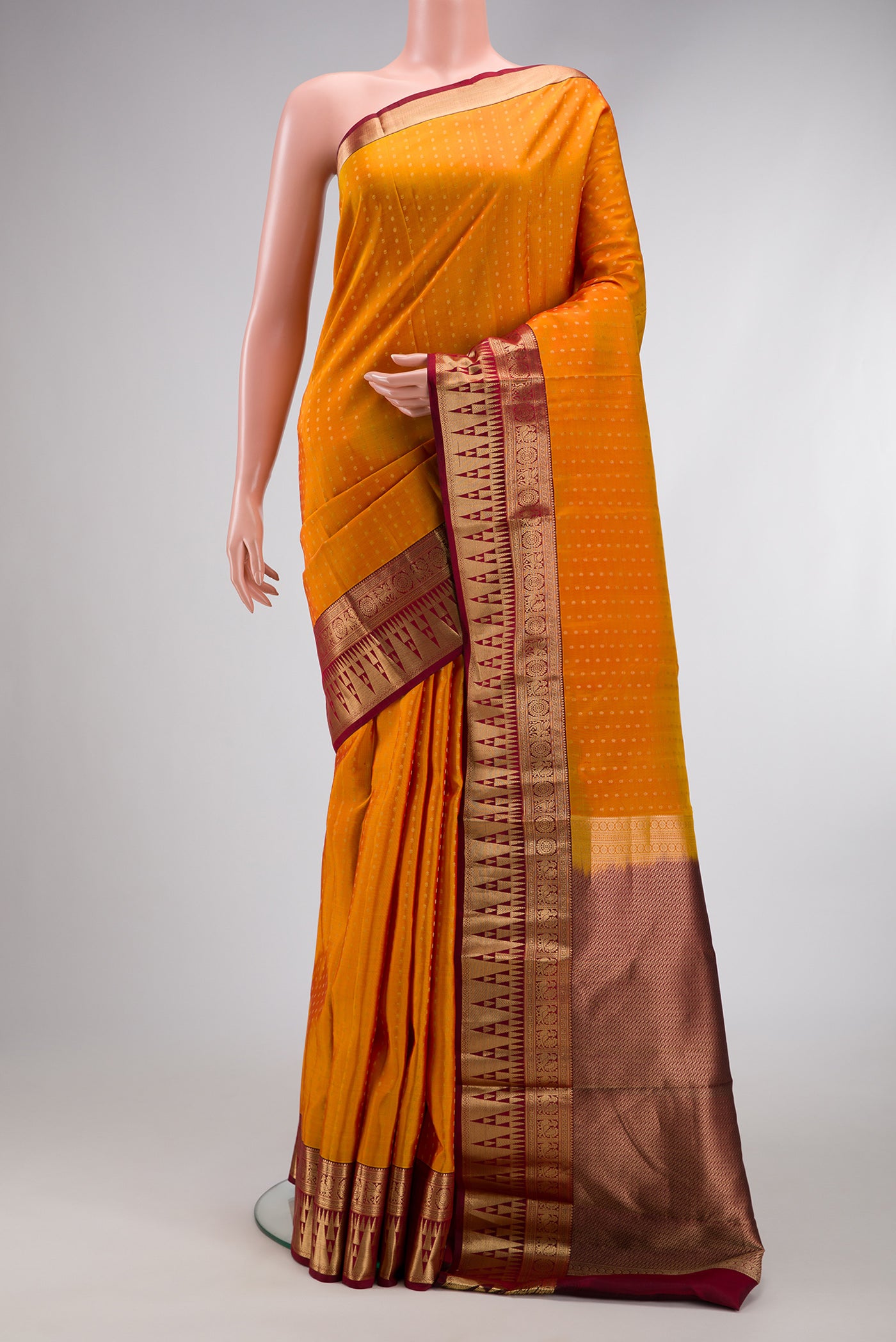 Mustard Dual Tone Kanchipuram Silk Saree with Zari Butta on the body and Fancy Border.  displayed on a mannequin