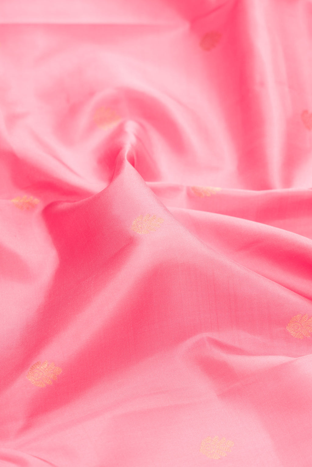 Close up of Pink Dual Tone Kanchipuram Silk Saree with Zari Butta on the body and Zari Border.  displaying folds