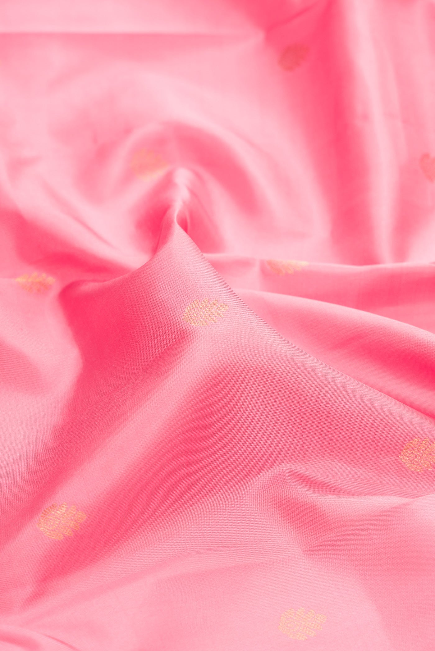 Close up of Pink Dual Tone Kanchipuram Silk Saree with Zari Butta on the body and Zari Border.  displaying folds
