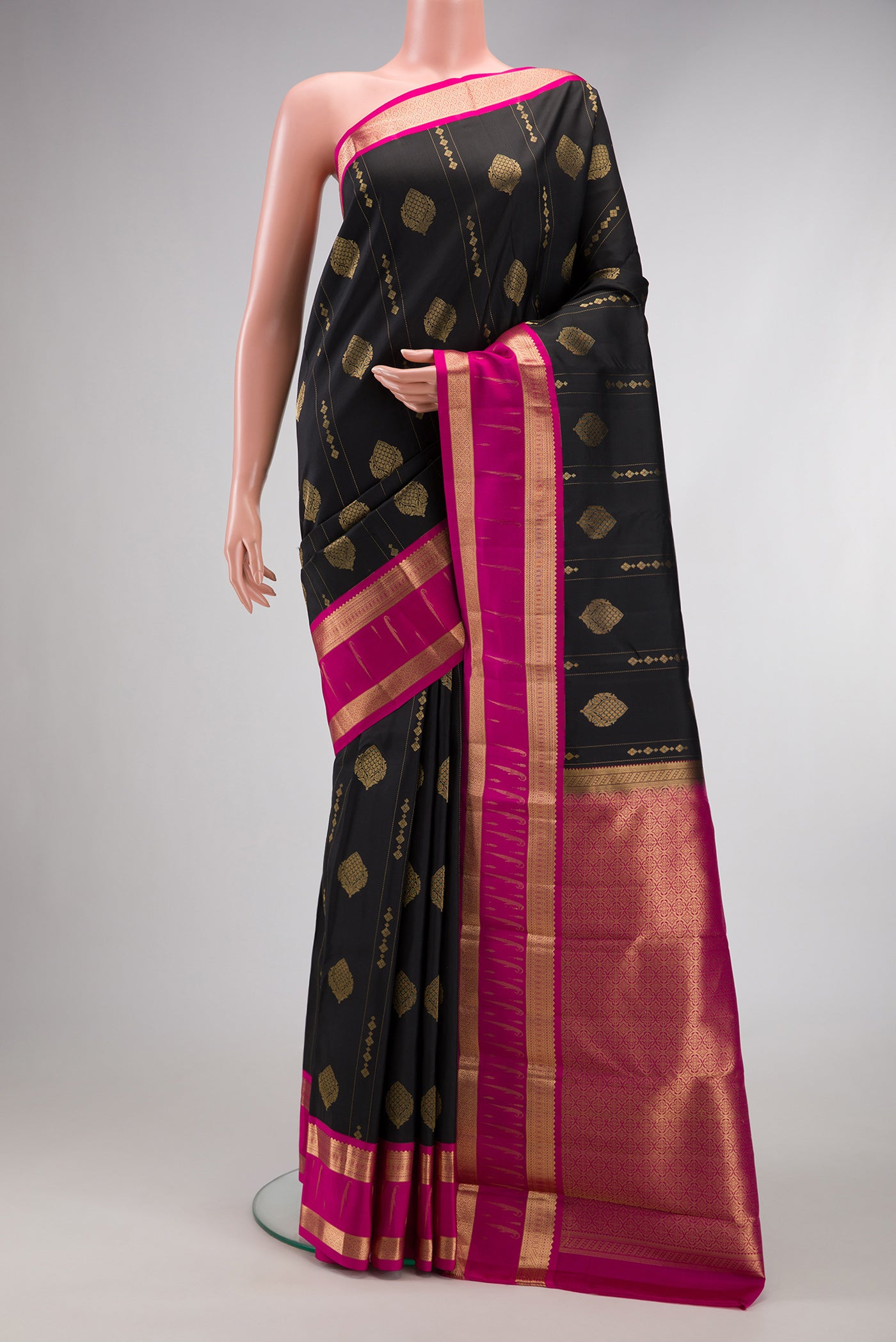 Black Dual Tone Kanchipuram Silk Saree with Zari Butta on the body and Zari Border.  displayed on a mannequin
