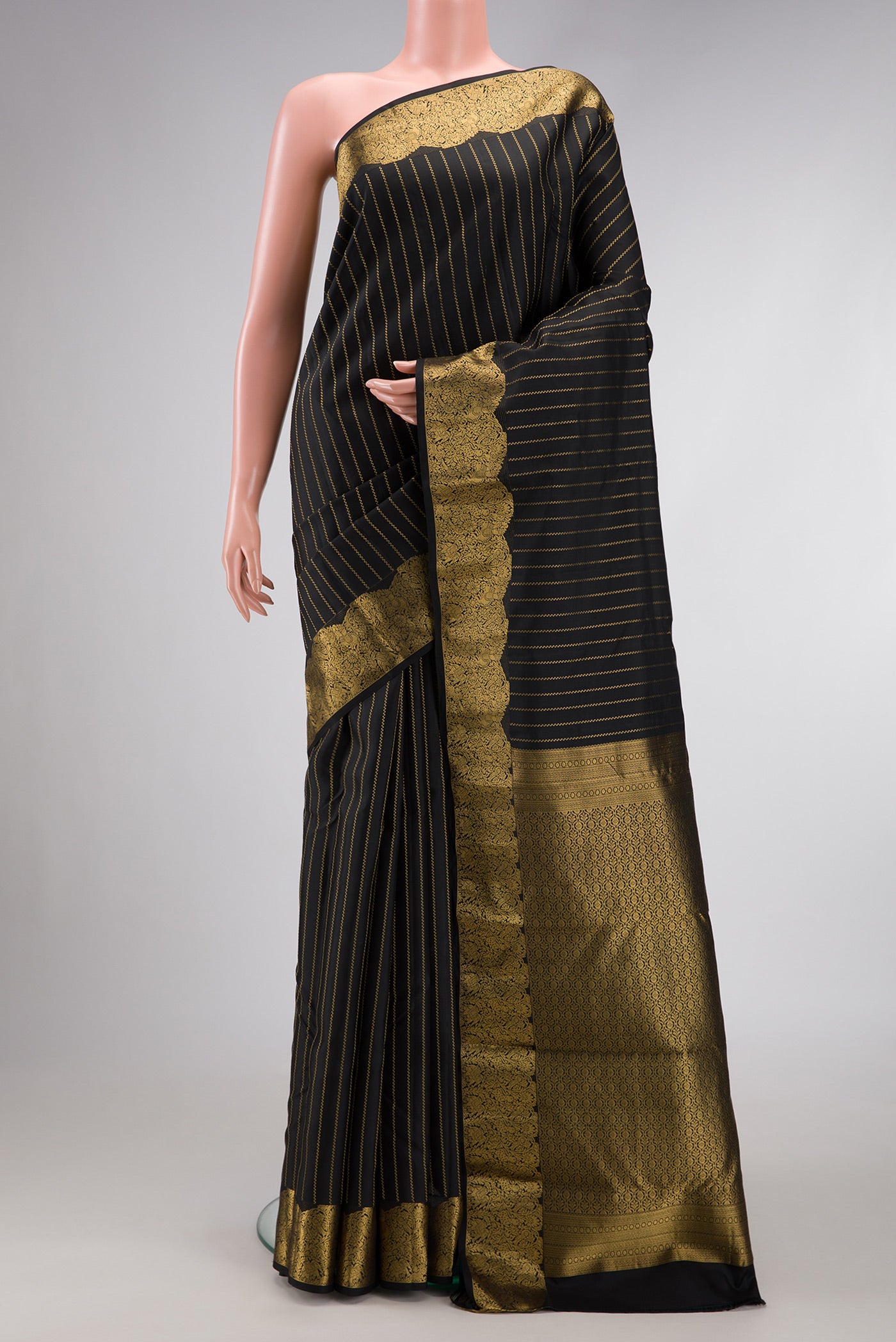 Black Dual Tone Kanchipuram Silk Saree with Stripes on the body and Fancy Border.  displayed on a mannequin