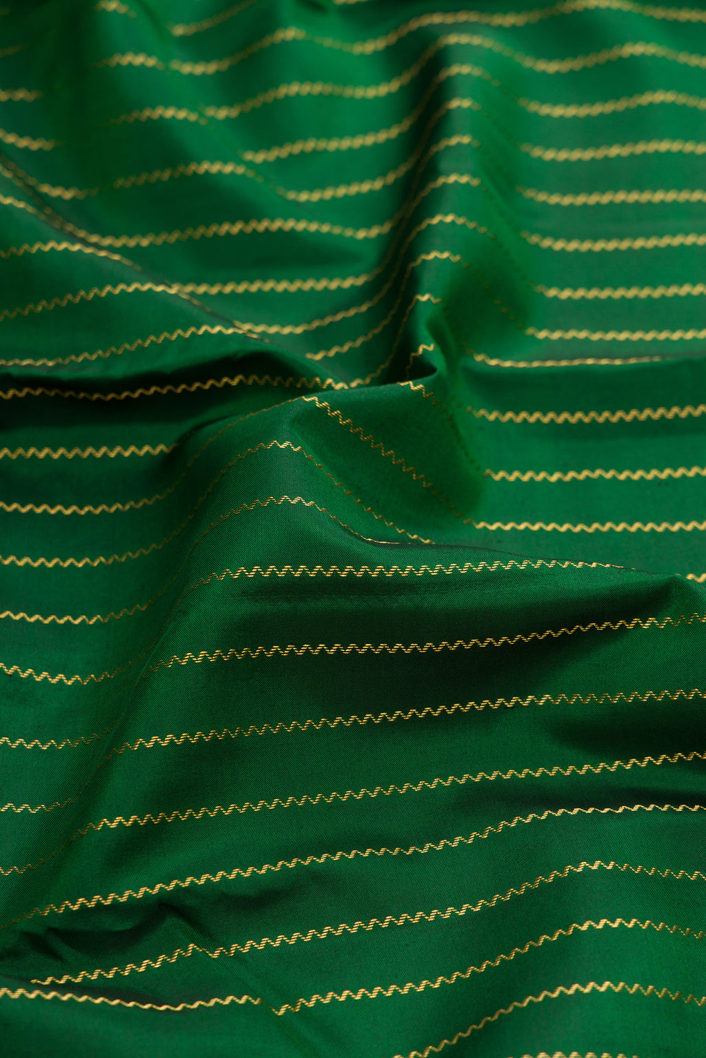 Close up of Bottle Green Dual Tone Kanchipuram Silk Saree with Stripes on the body and Fancy Border.  displaying folds