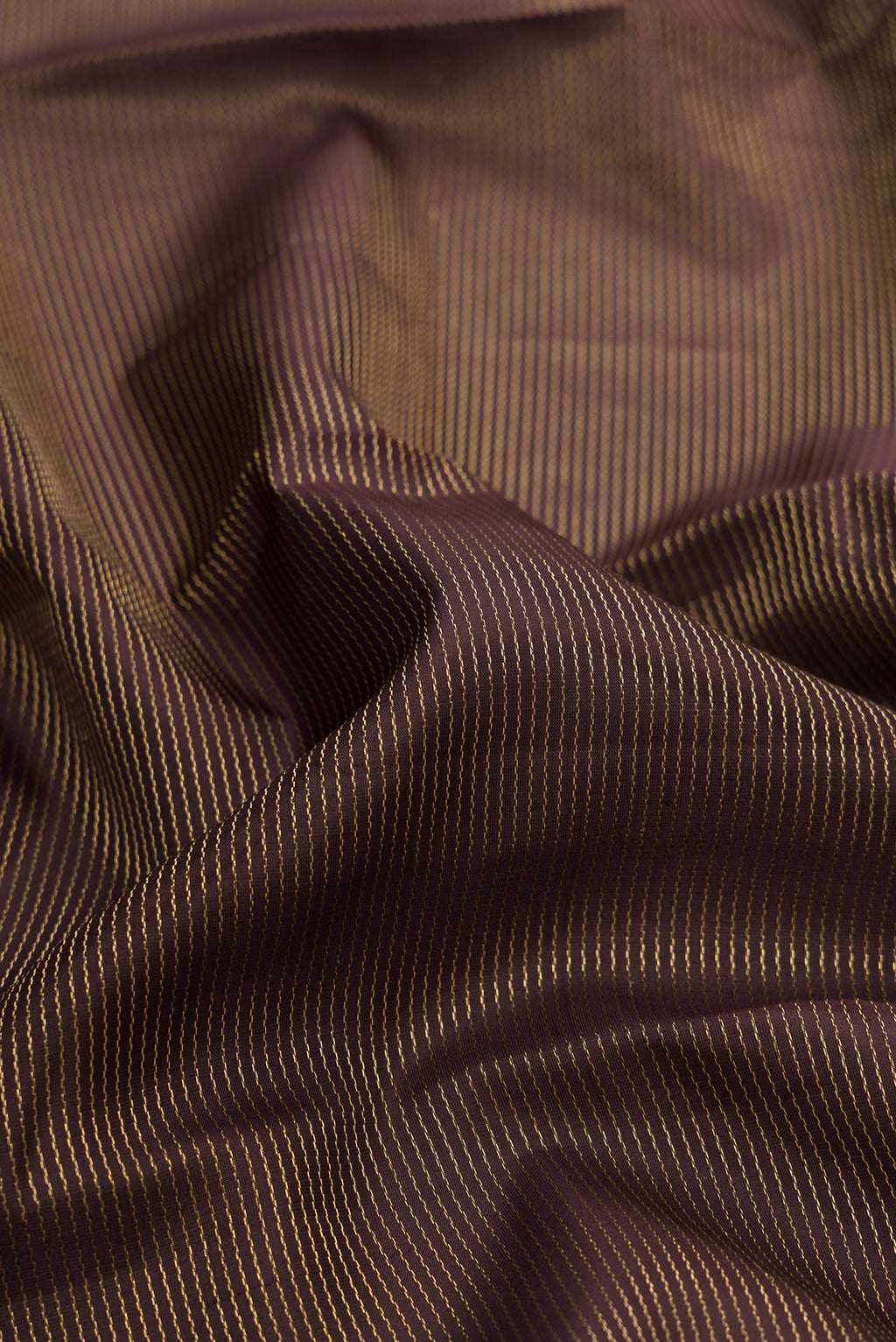 Close up of Coffee Brown Dual Tone Kanchipuram Silk Saree with Stripes on the body and Zari Border.  displaying folds
