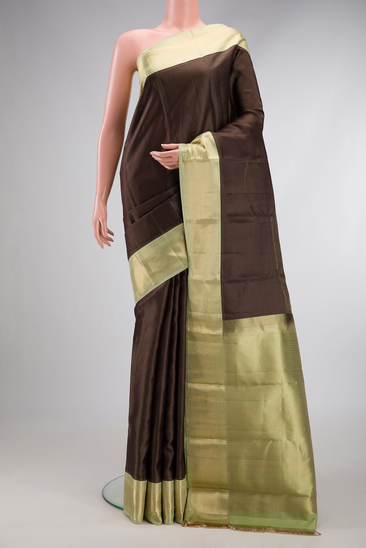 Coffee Brown Dual Tone Kanchipuram Silk Saree with Stripes on the body and Zari Border.  displayed on a mannequin