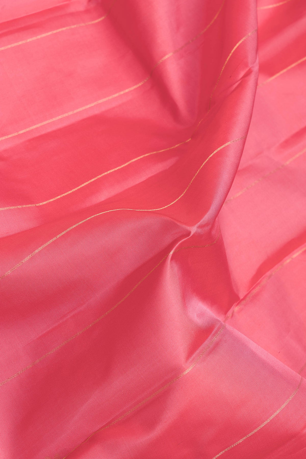 Close up of Pink Dual Tone Kanchipuram Silk Saree with Stripes on the body and Zari Border.  displaying folds