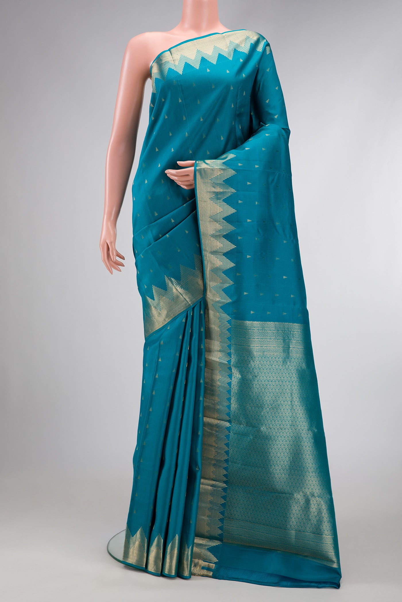 Peacock Blue Dual Tone Kanchipuram Silk Saree with Zari Butta on the body and Fancy Border.  displayed on a mannequin