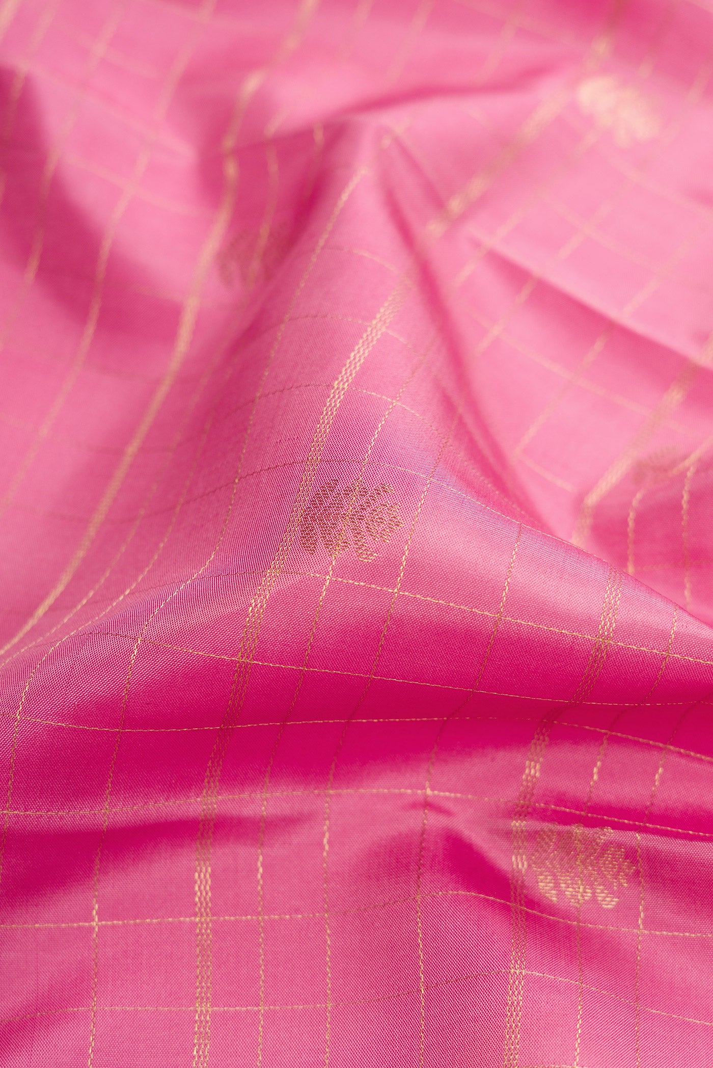 Close up of Pink Dual Tone Kanchipuram Silk Saree with Checked design on the body and Zari Border.  displaying folds