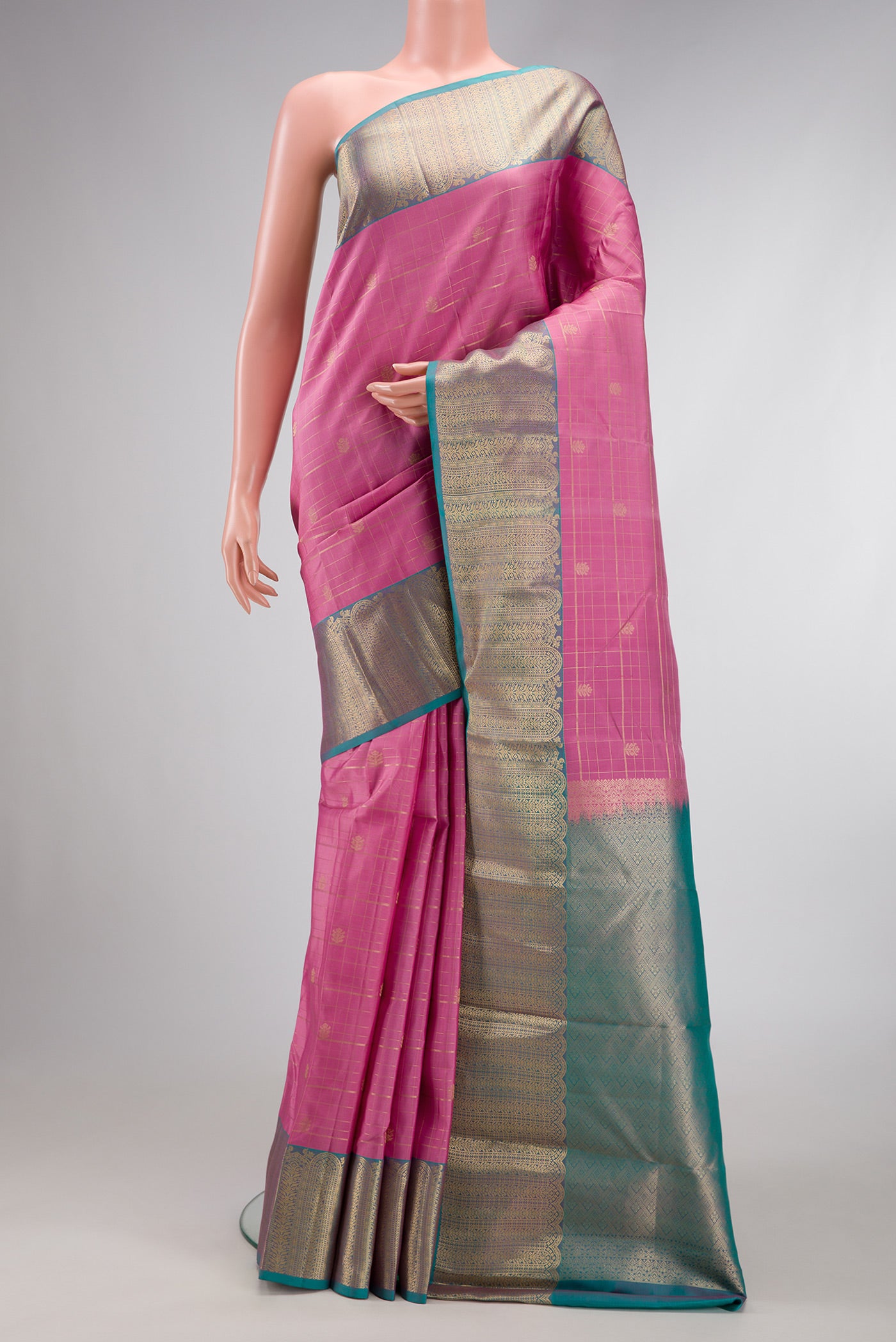 Pink Dual Tone Kanchipuram Silk Saree with Checked design on the body and Zari Border.  displayed on a mannequin