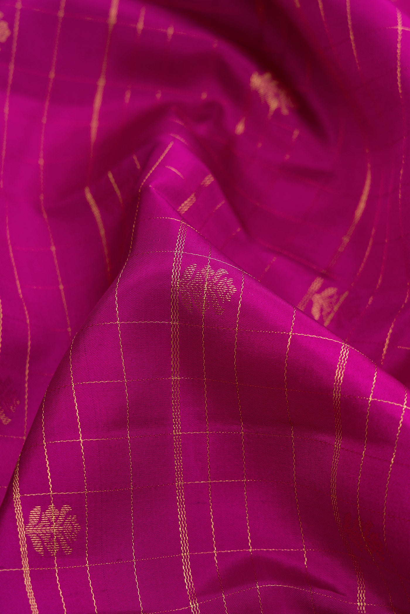 Close up of Dark Pink Dual Tone Kanchipuram Silk Saree with Stripes on the body and Zari Border.  displaying folds