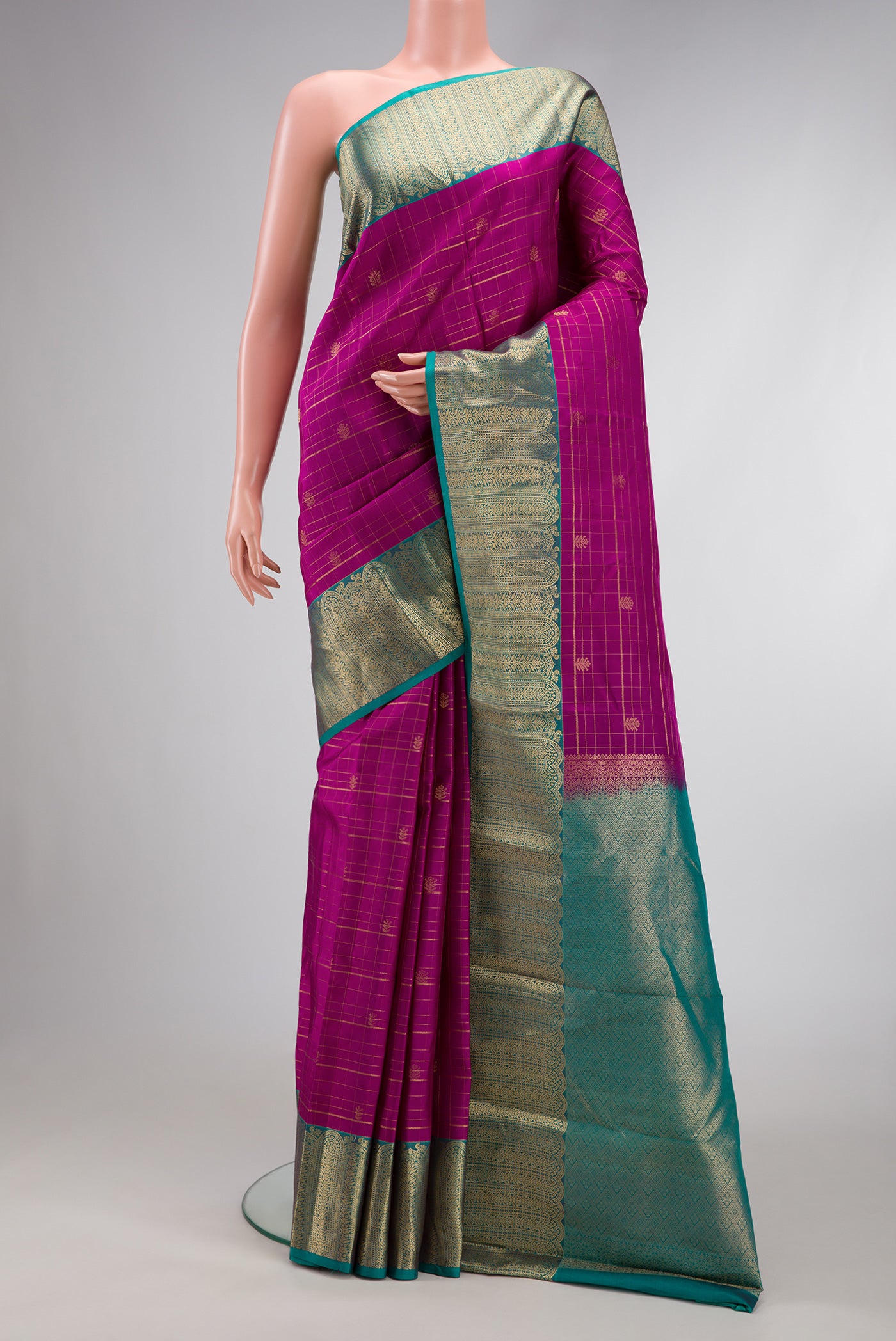 Dark Pink Dual Tone Kanchipuram Silk Saree with Stripes on the body and Zari Border.  displayed on a mannequin