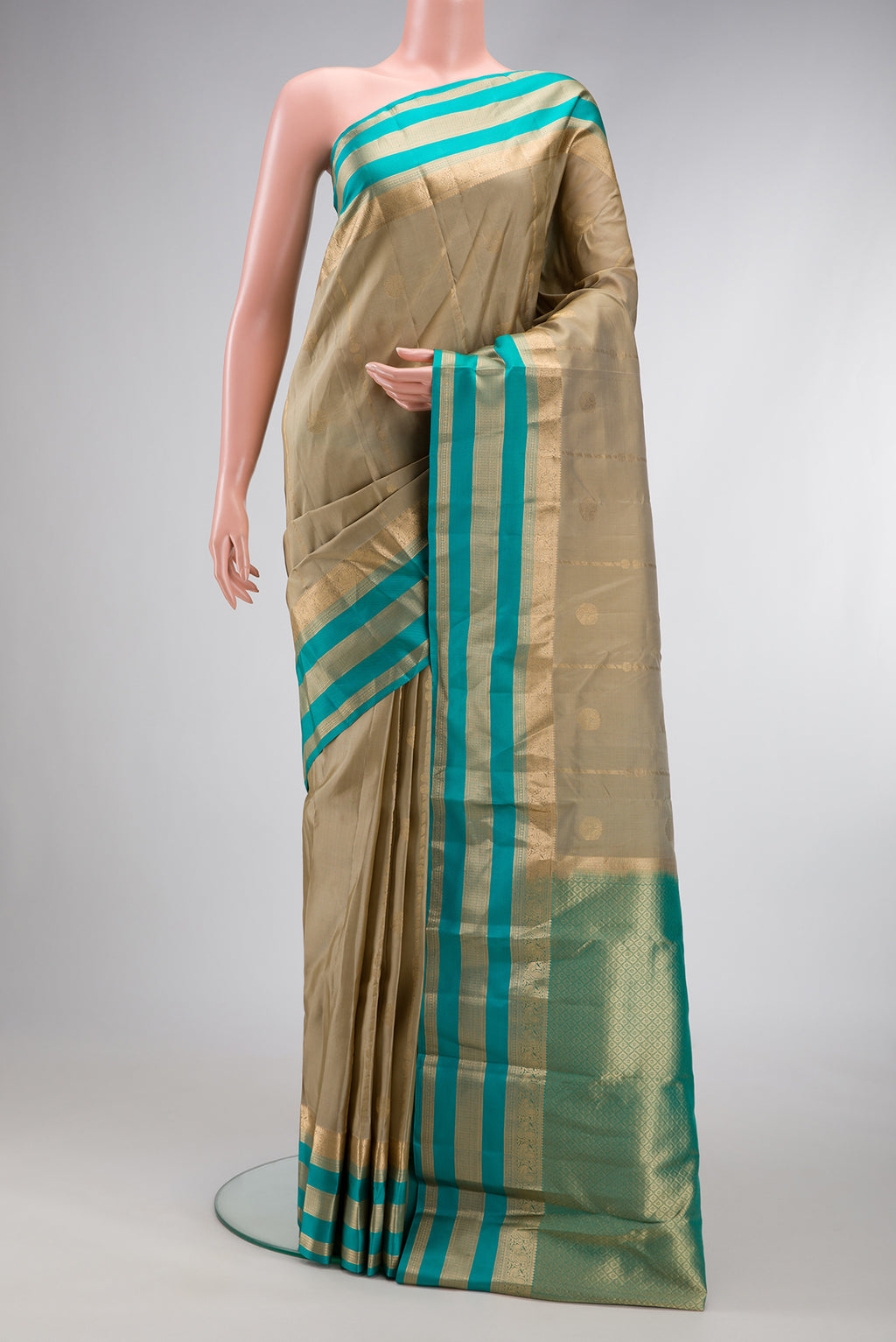 Dark Beige Dual Tone Kanchipuram Silk Saree with Zari Butta on the body and Zari Border.  displayed on a mannequin
