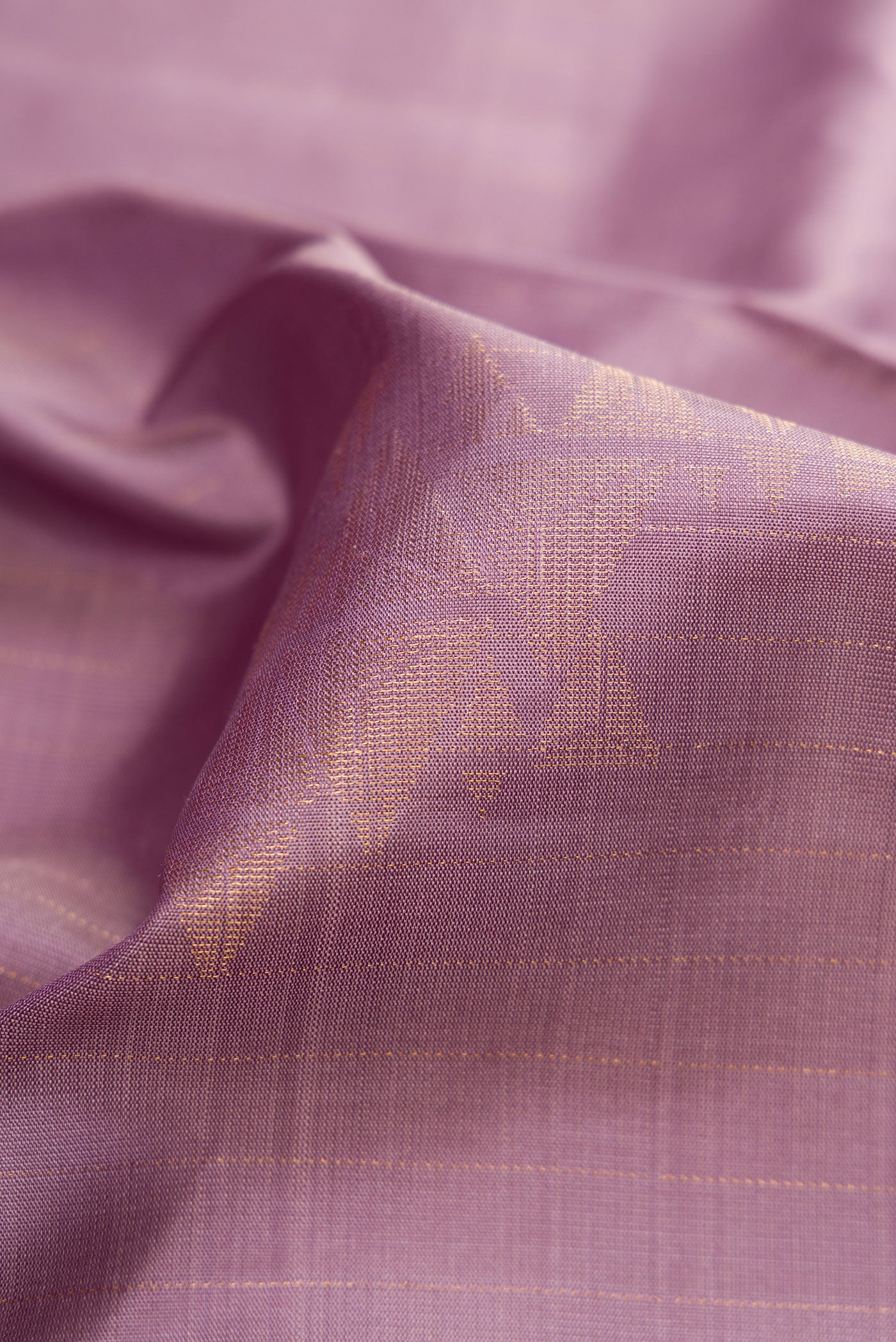Close up of Lilac Dual Tone Soft Silk Saree with Zari Butta on the body and Zari Border.  displaying folds