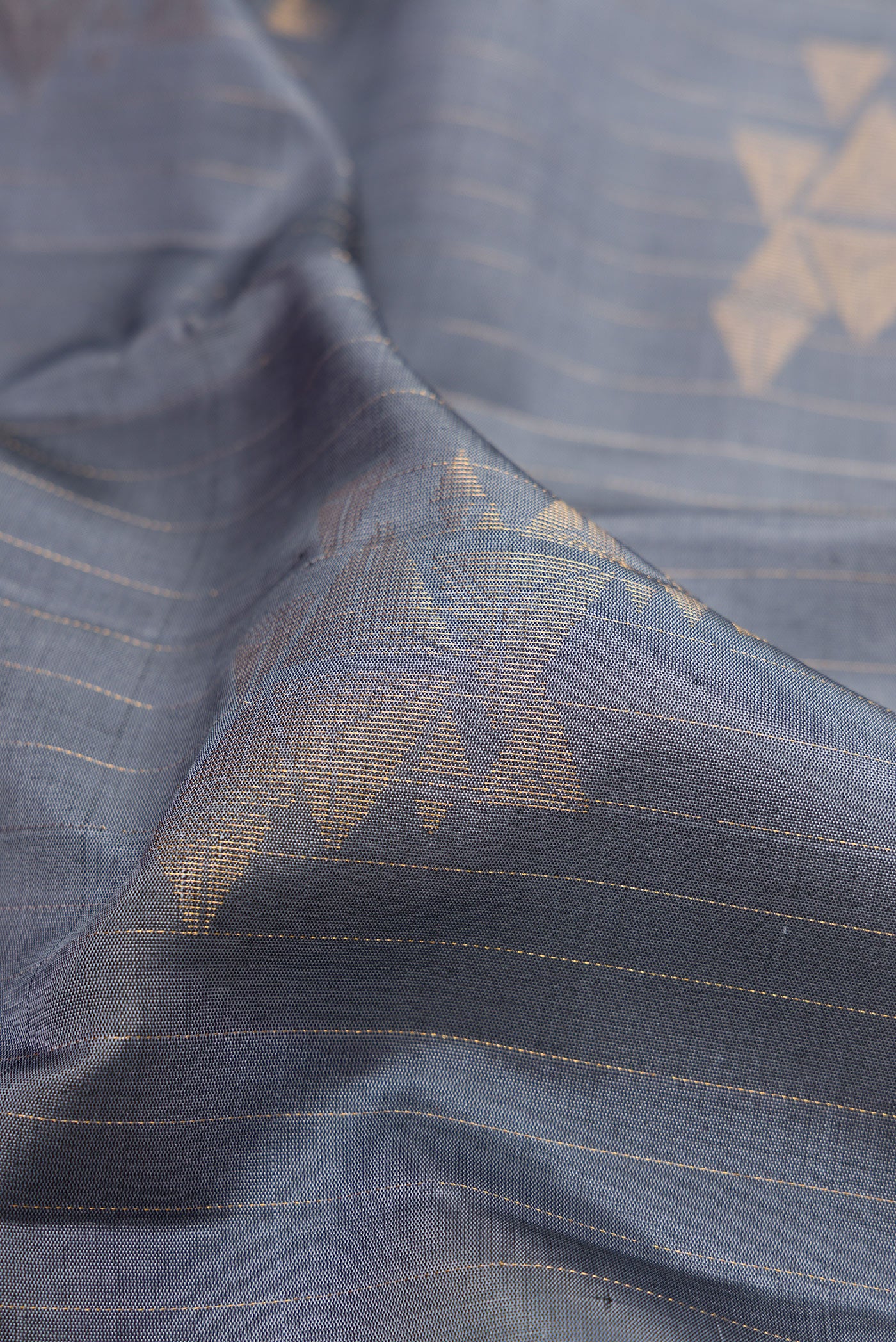 Close up of Grey Dual Tone Soft Silk Saree with Stripes on the body and Without Border.  displaying folds