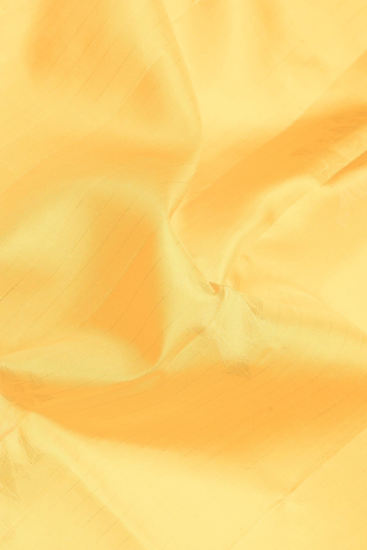 Close up of Yellow Soft Silk Saree with Stripes on the body and Without Border.  displaying folds